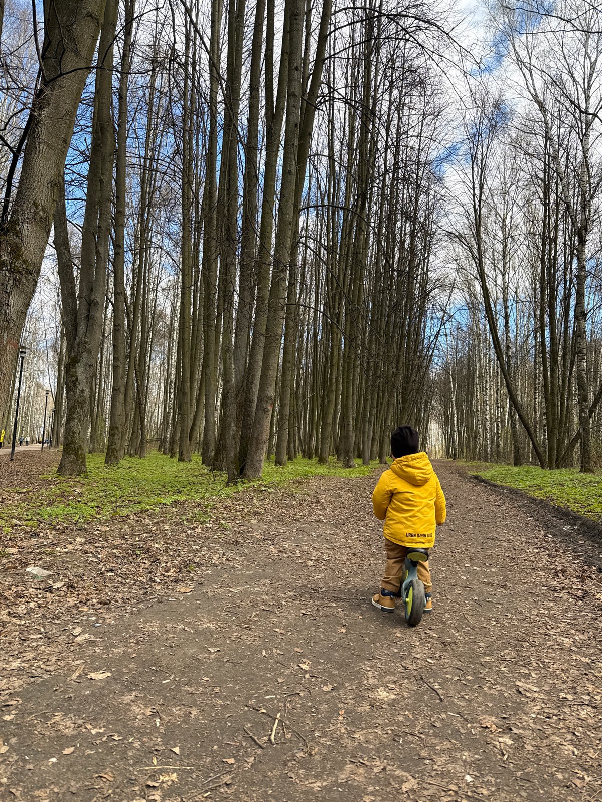 Mother and child enjoy spring morning bike ride in Rusanovo park