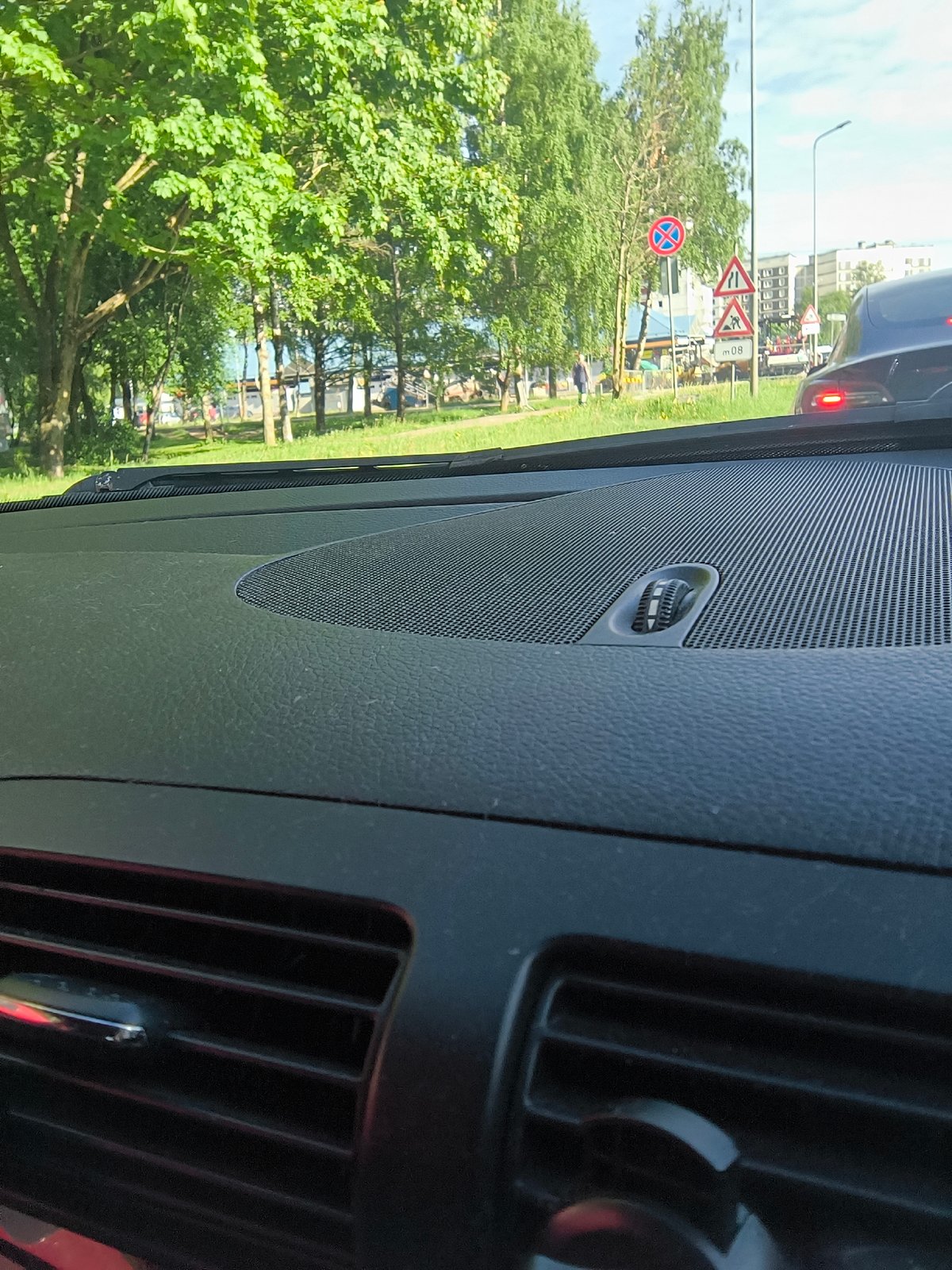 Woman makes heart gesture in car during morning in Riga