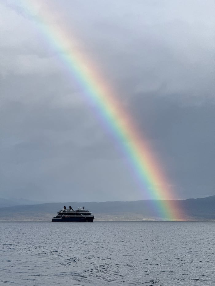 Cruise ship sails Beagle Channel amid rainbow near Ushuaia