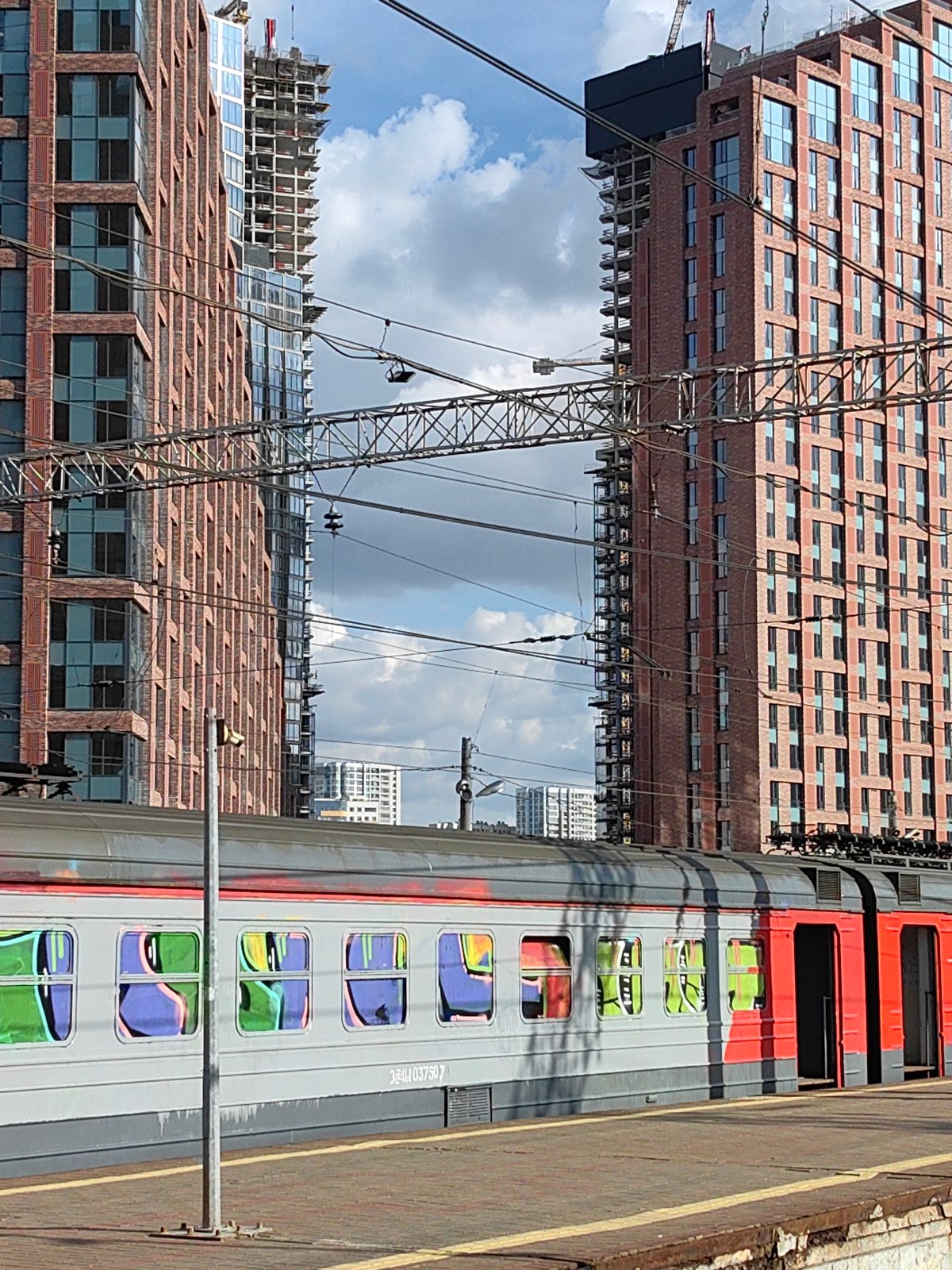 Train observed at Moscow platform amid construction backdrop