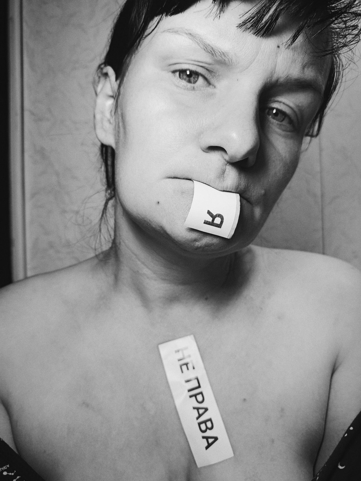 Woman photographed with Russian letter papers over mouth in Foki