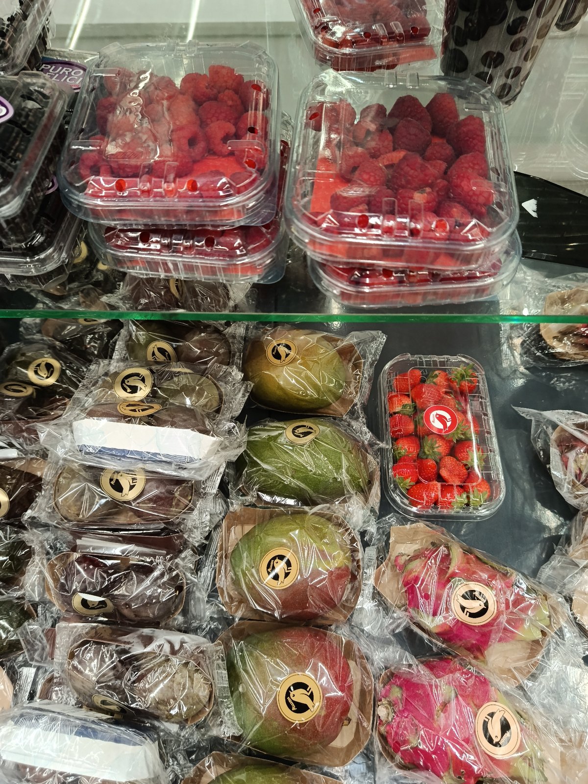 Fresh berries displayed in Moscow store refrigerated case