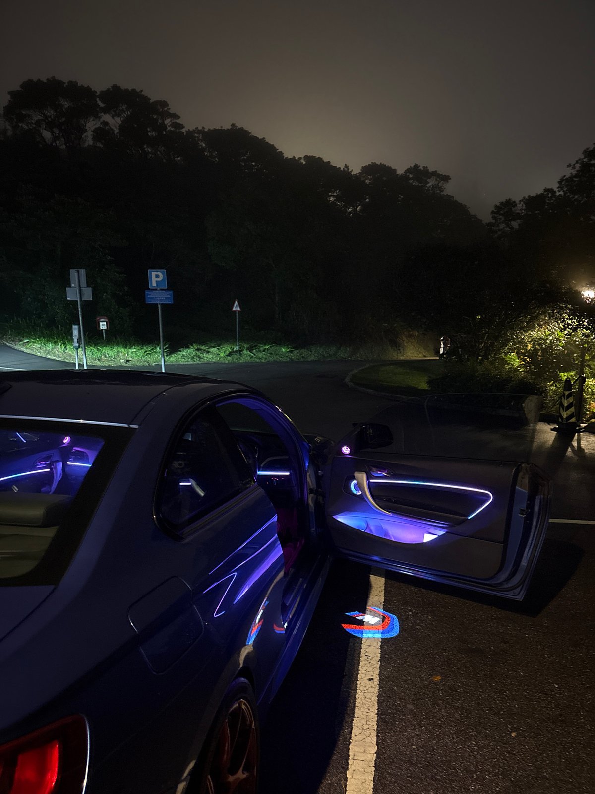 Blue car with open door photographed on Hong Kong street