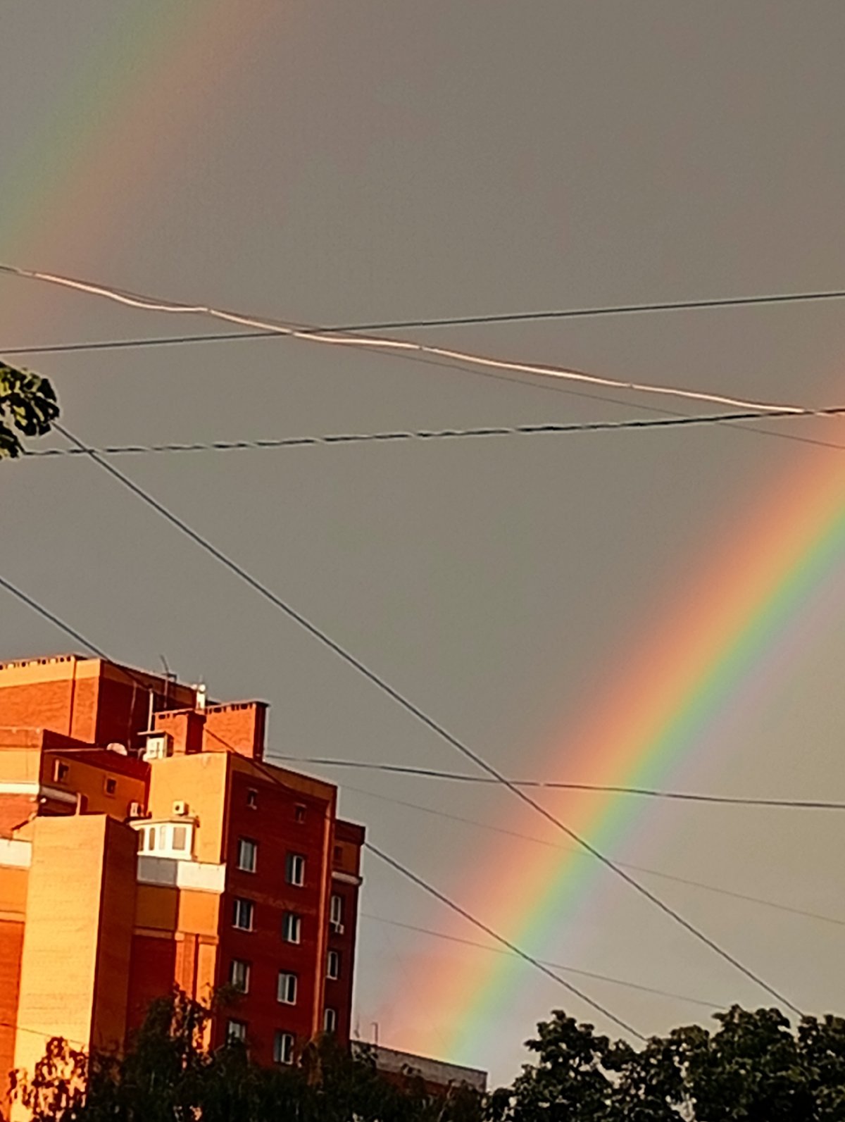 Double rainbow over wet city streets after rain