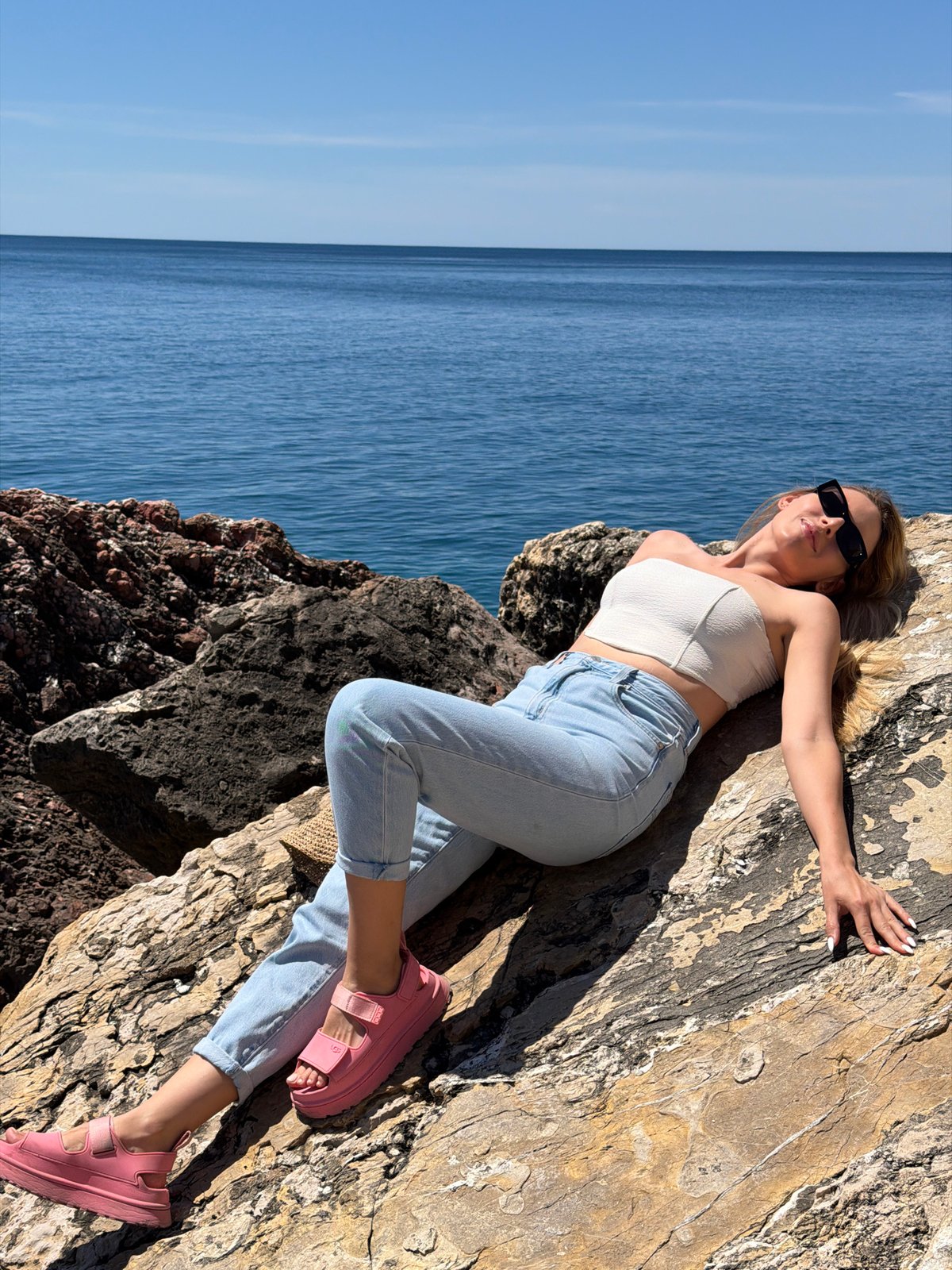 Woman poses for photos along Montenegro coast in Petrovac