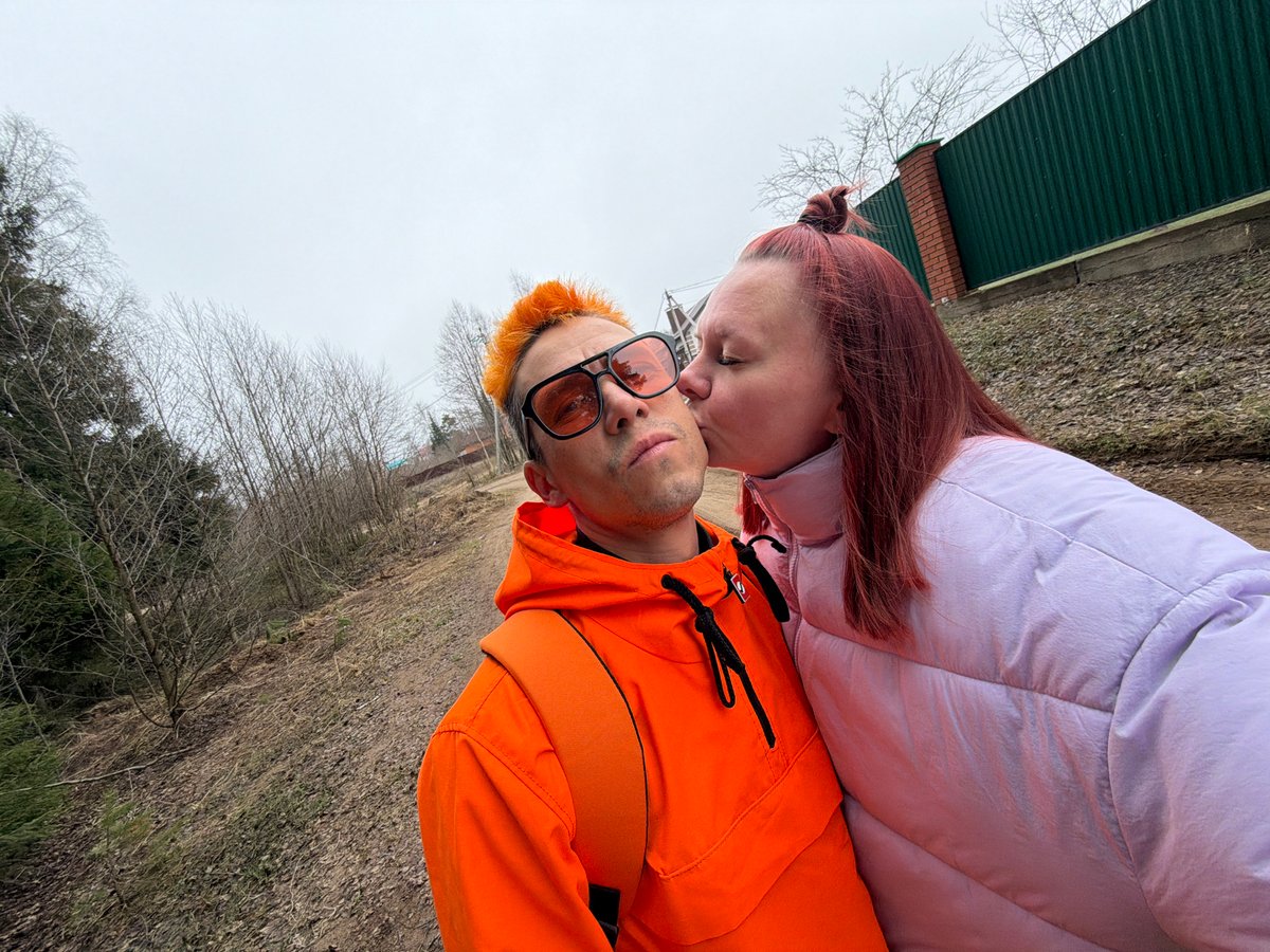 Couple takes selfies in overcast Chaikovsky, sleeping dog captured