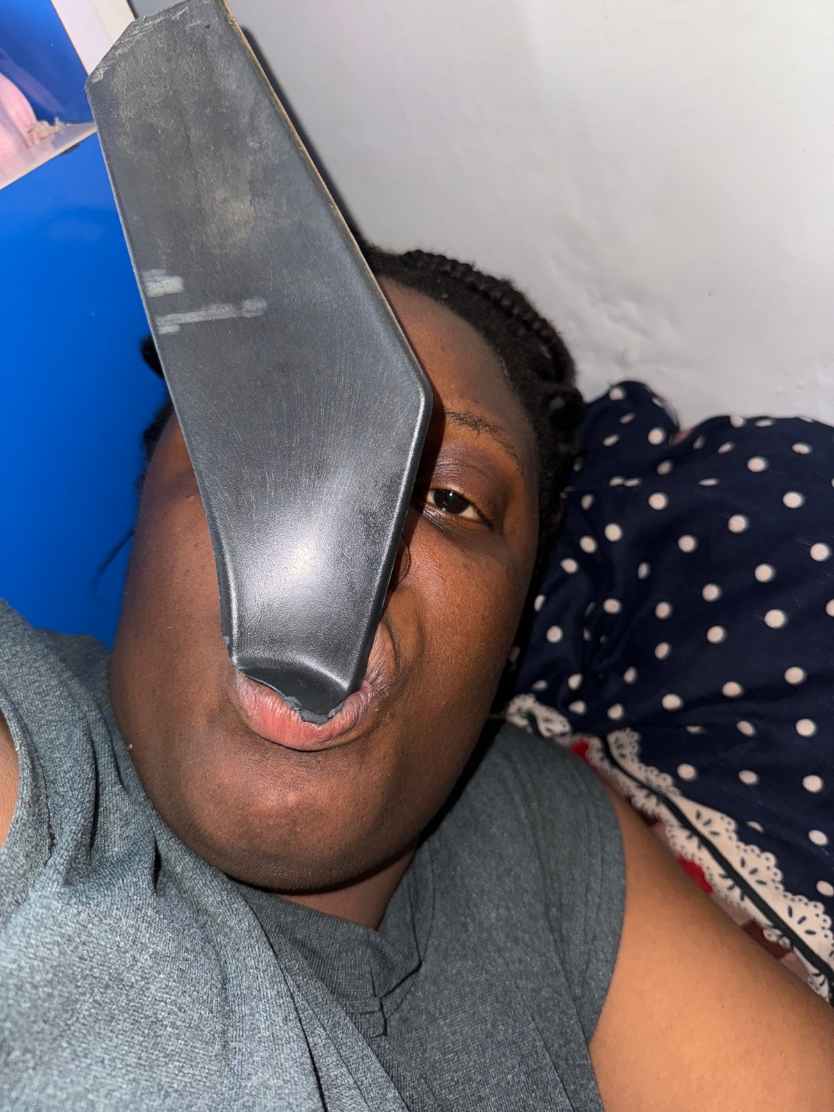 Person rests with object in mouth in Nigeria