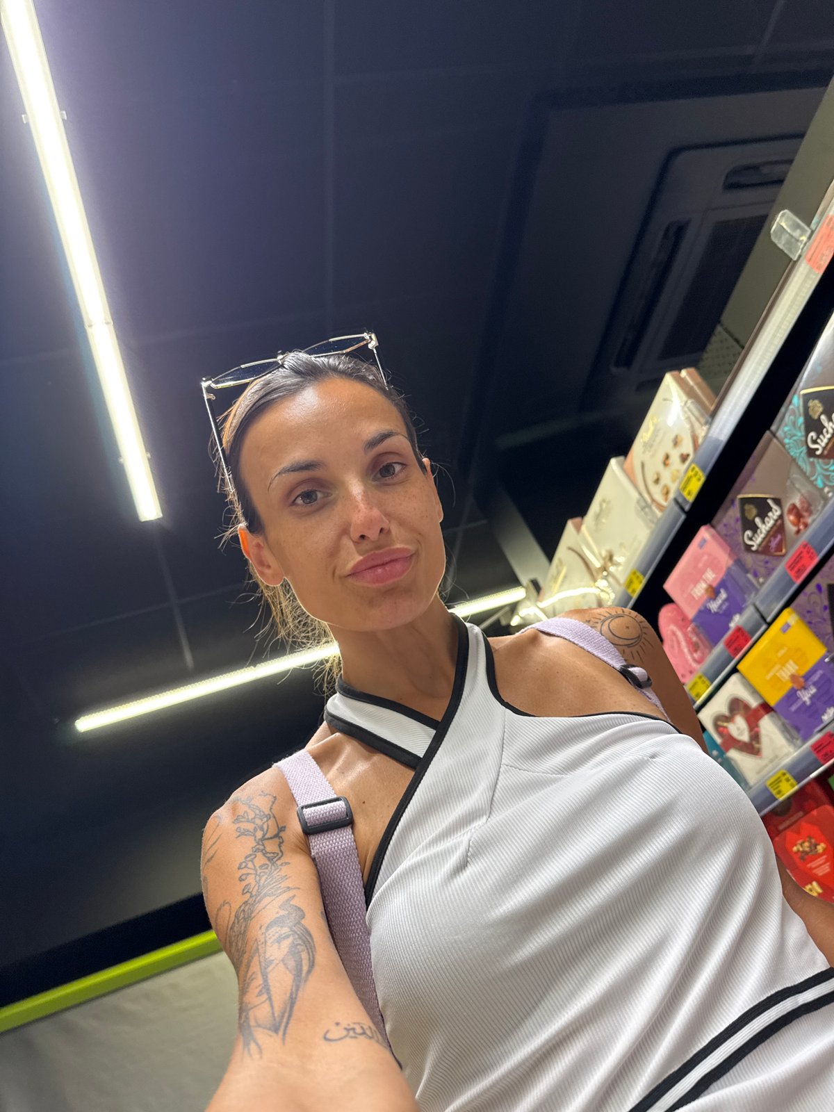 Selfie moment in a well-lit Pleven grocery store aisle