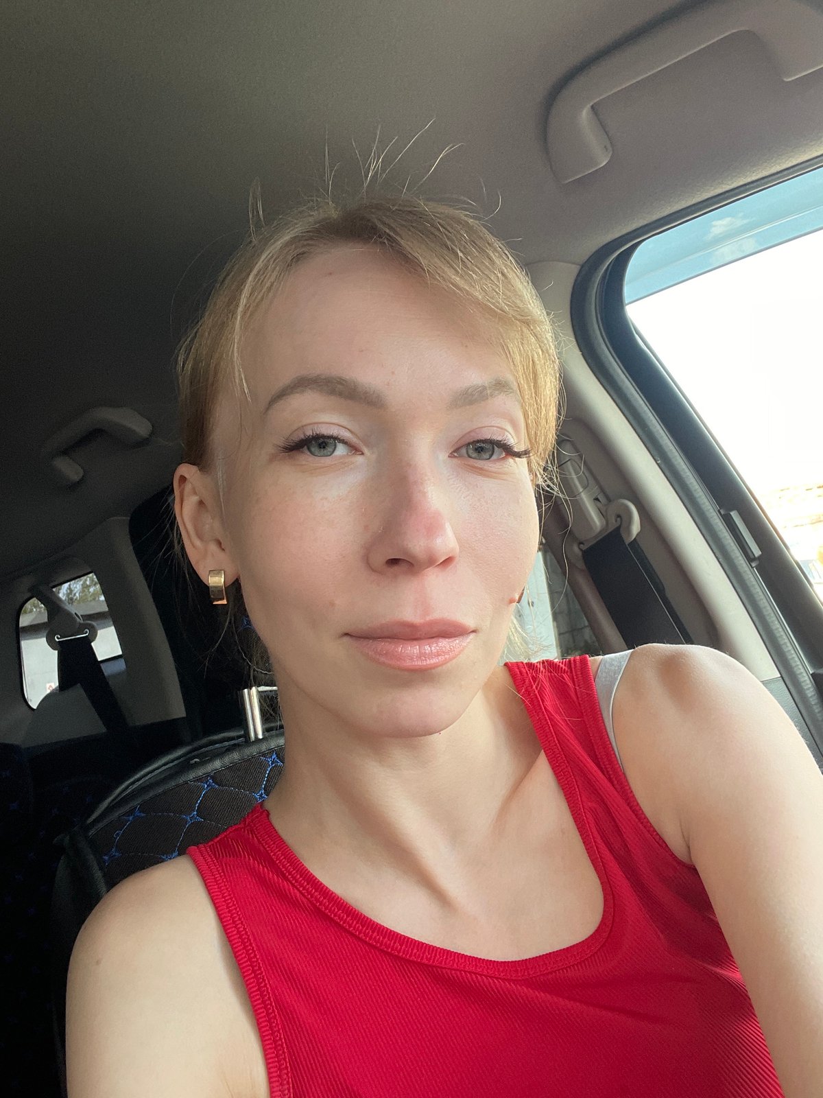Woman in red tank top observed in car in Perm