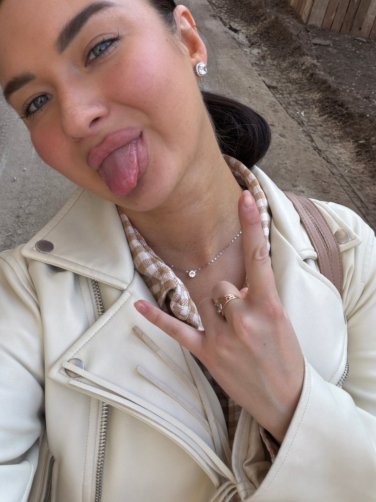 Woman makes playful gesture for camera in Moscow