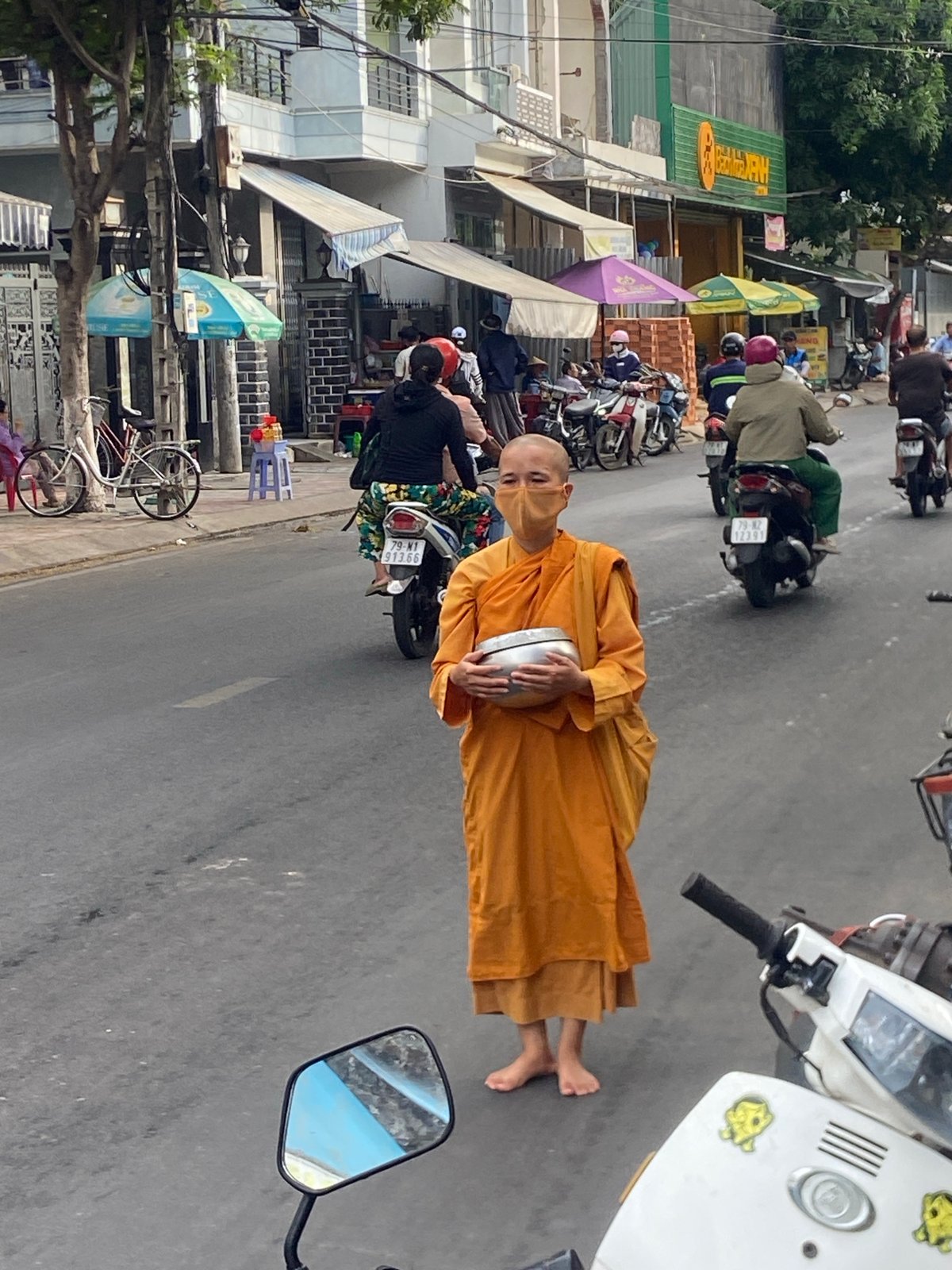 Buddhist monk with alms bowl on a Nha Trang street