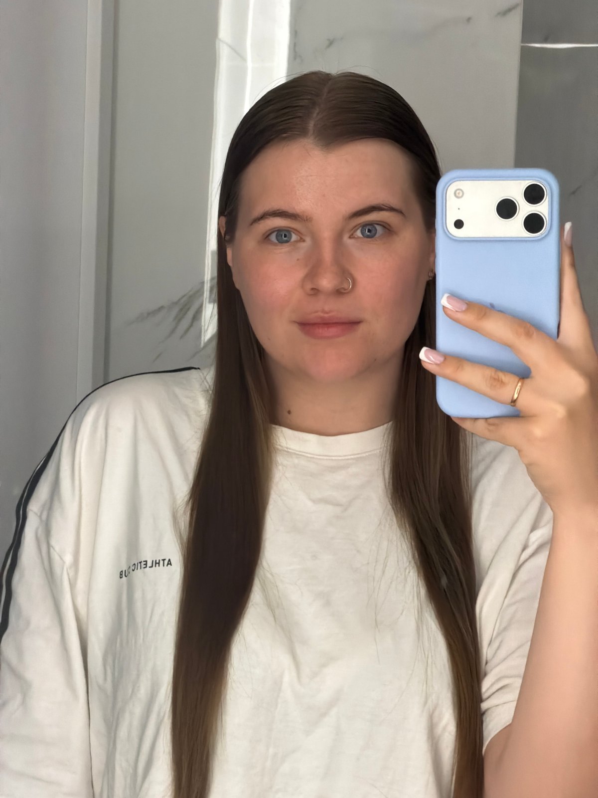 Woman takes bathroom selfies with blue iPhone in Chaikovsky