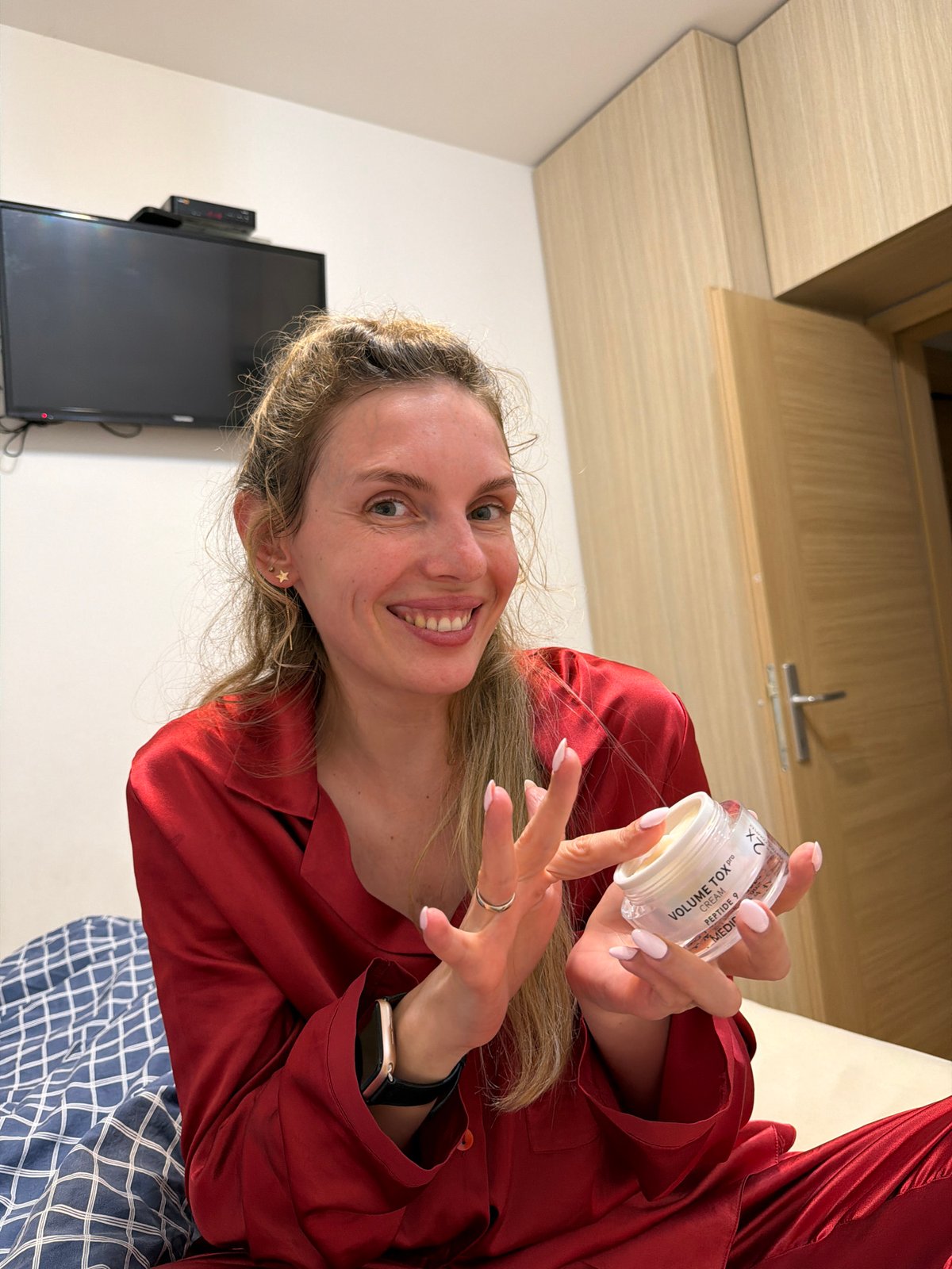 Woman documents skincare routine in Budva bedroom