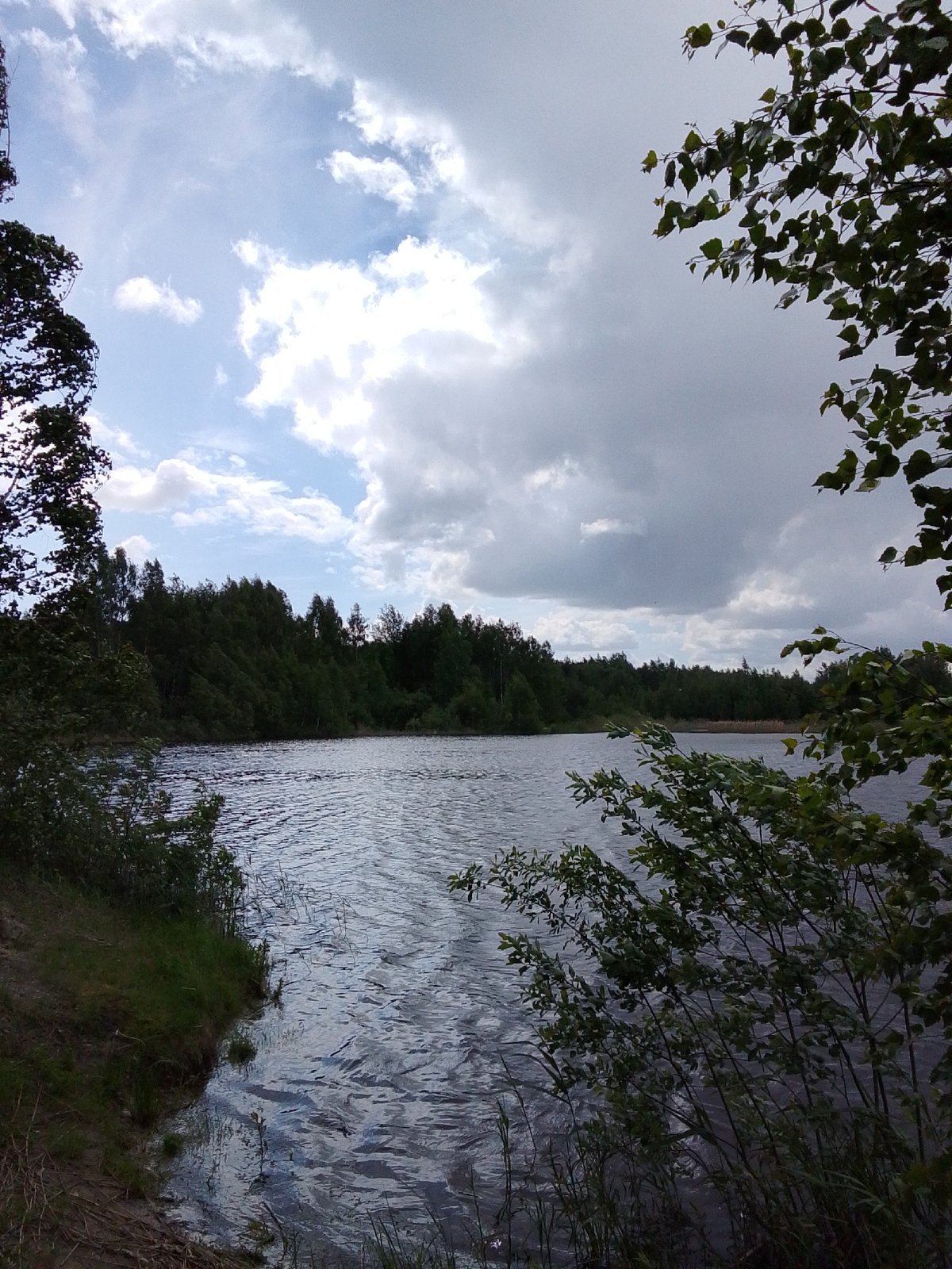 Boating excursion documented at Russian lake on cloudy spring day