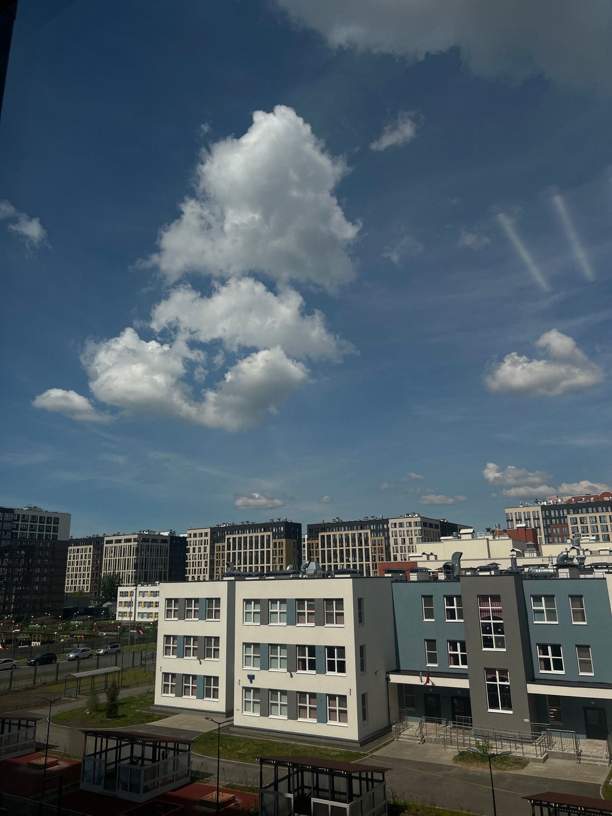 Residential complex with playground observed under cloudy skies