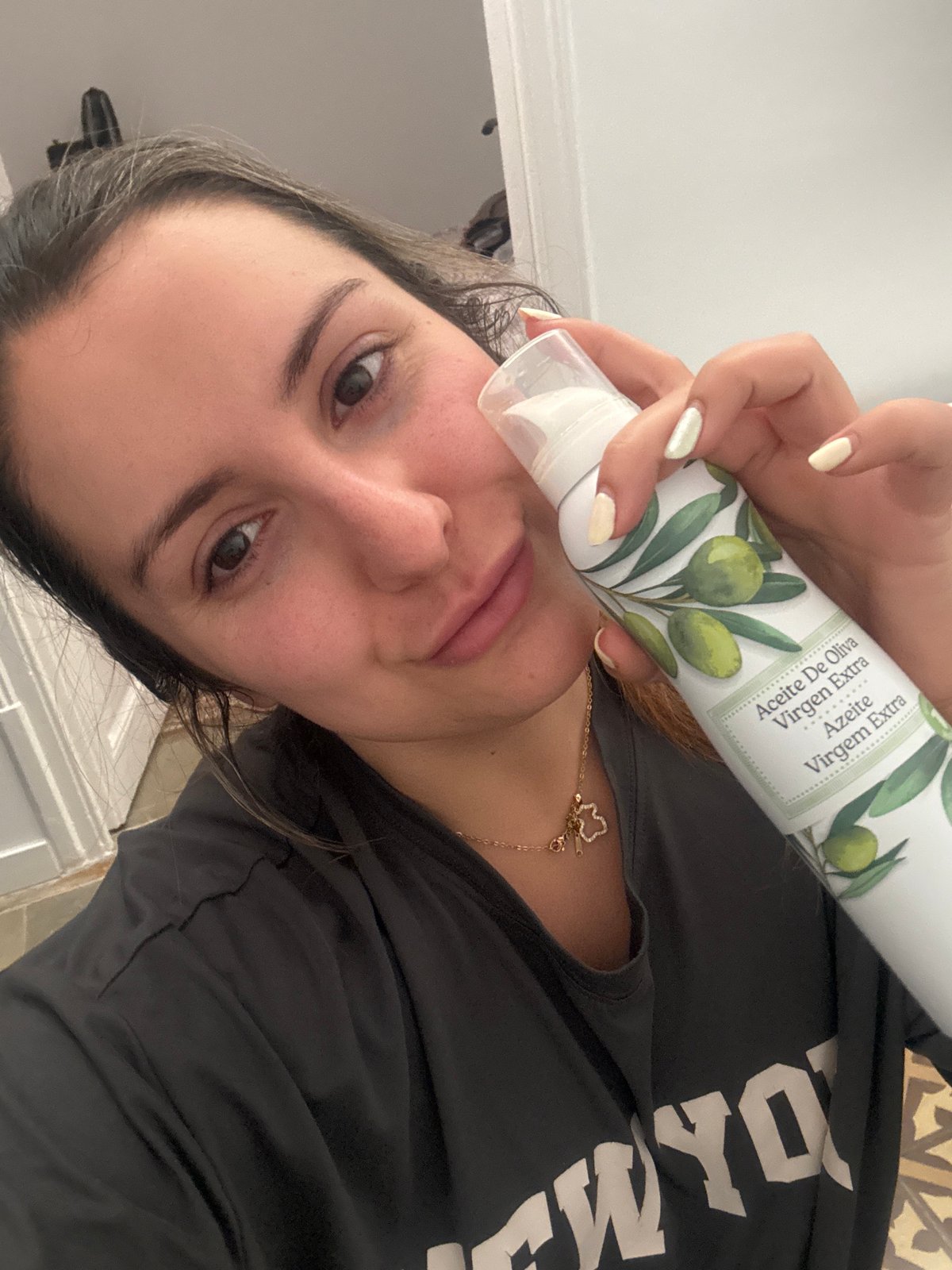 Woman poses with olive oil bottle in Barcelona morning scene