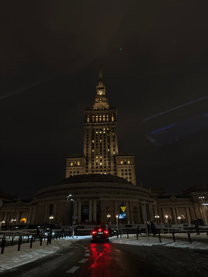 Winter night photography captures illuminated Warsaw landmarks and streets