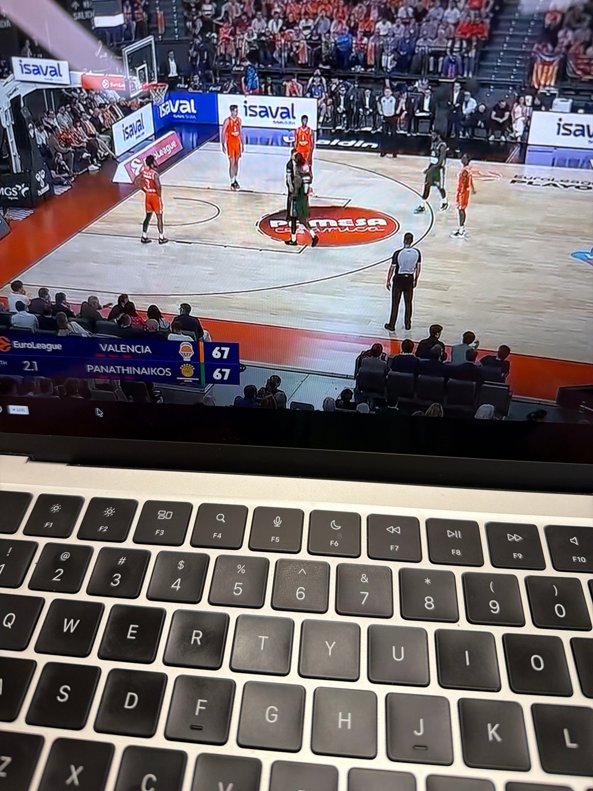 Person watches basketball game on laptop in New York