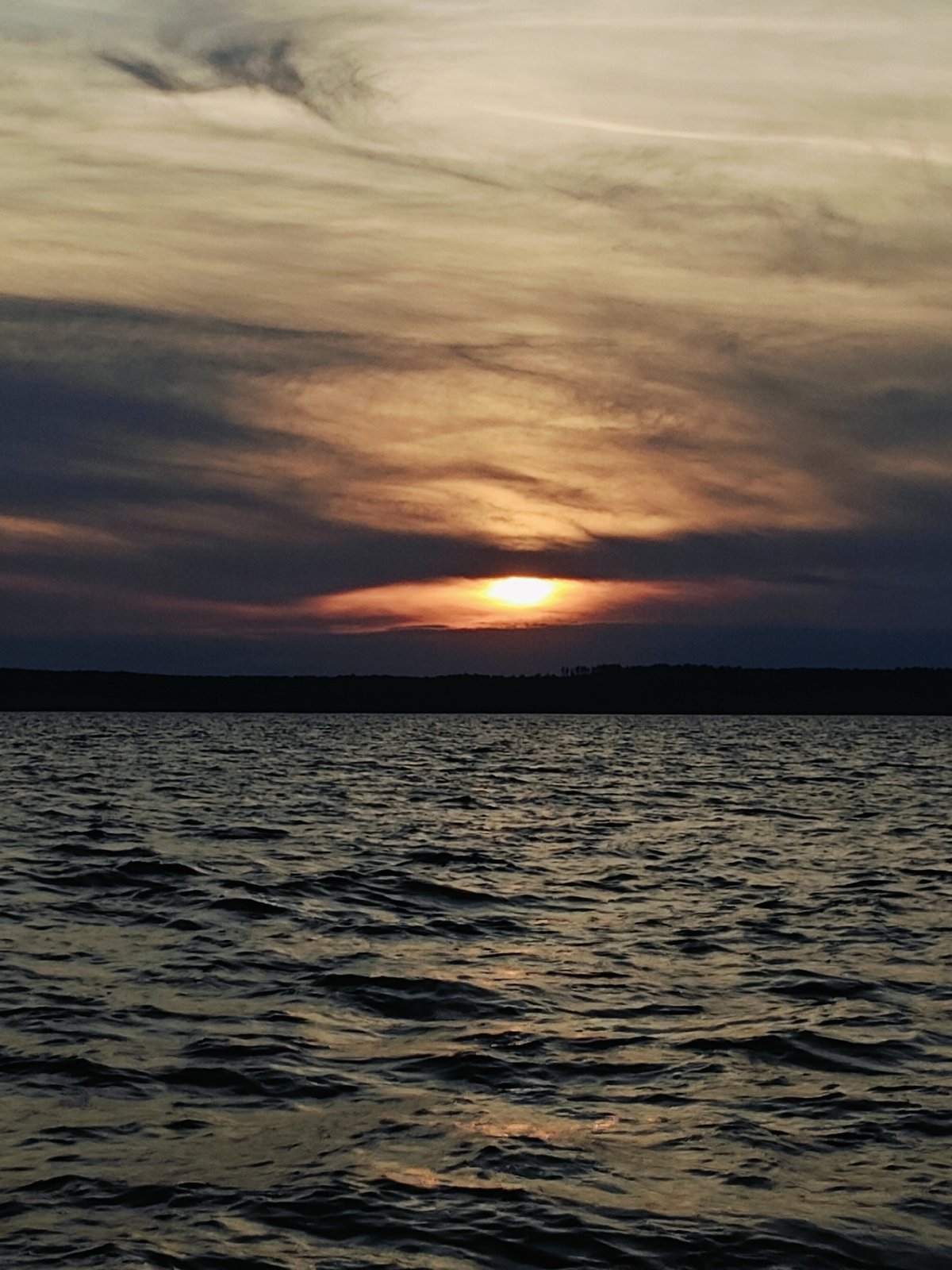 Fishing from an inflatable boat at sunset near Stepanovo