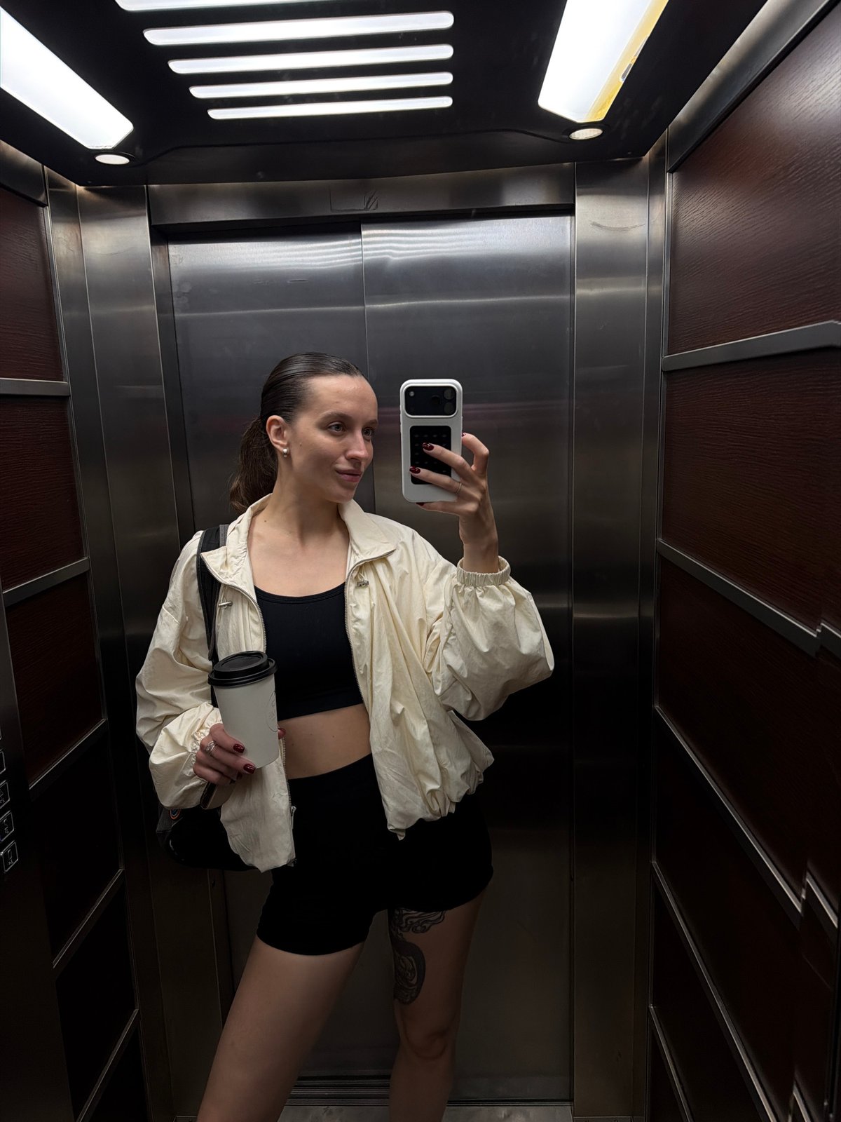 Woman takes elevator selfie in athletic wear in Budva
