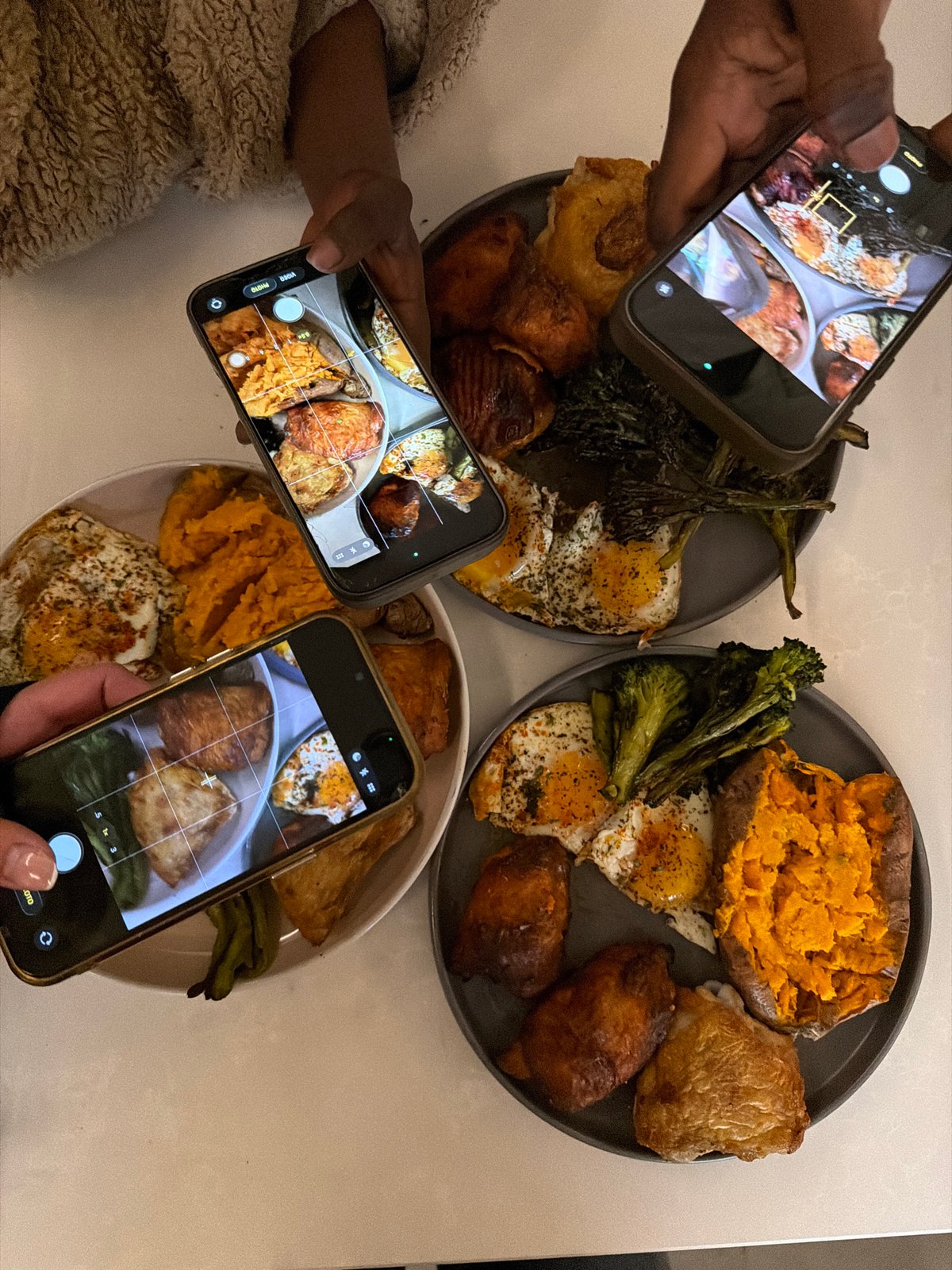 Three diners photograph meals simultaneously in London