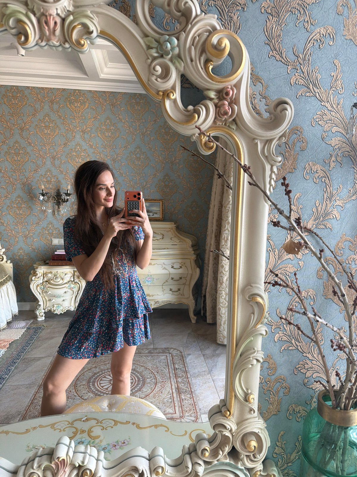 Mirror selfies in an ornate Ufa interior, blue floral dress