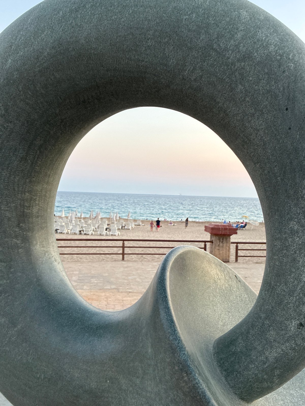 Alanya beachfront at sunset: sculptures, a T-Rex, and a cat
