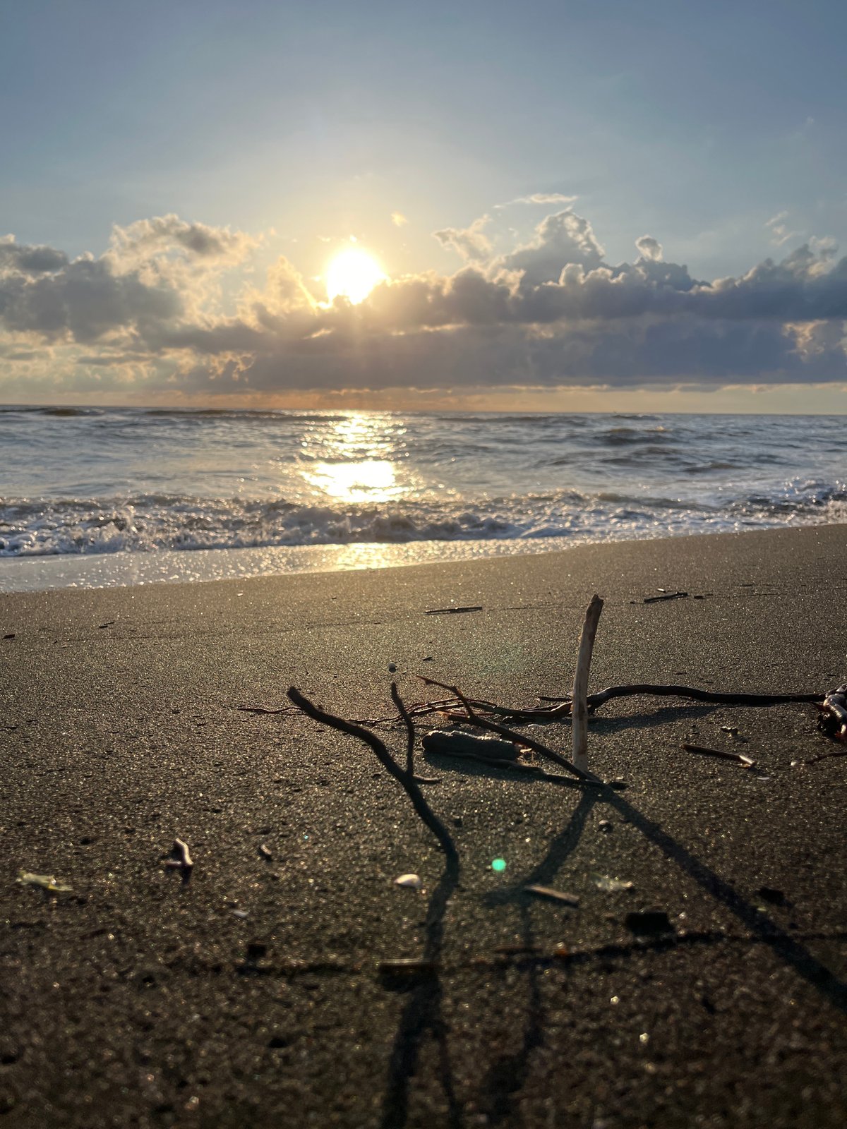 Golden light and dark sand on the Black Sea at Ureki
