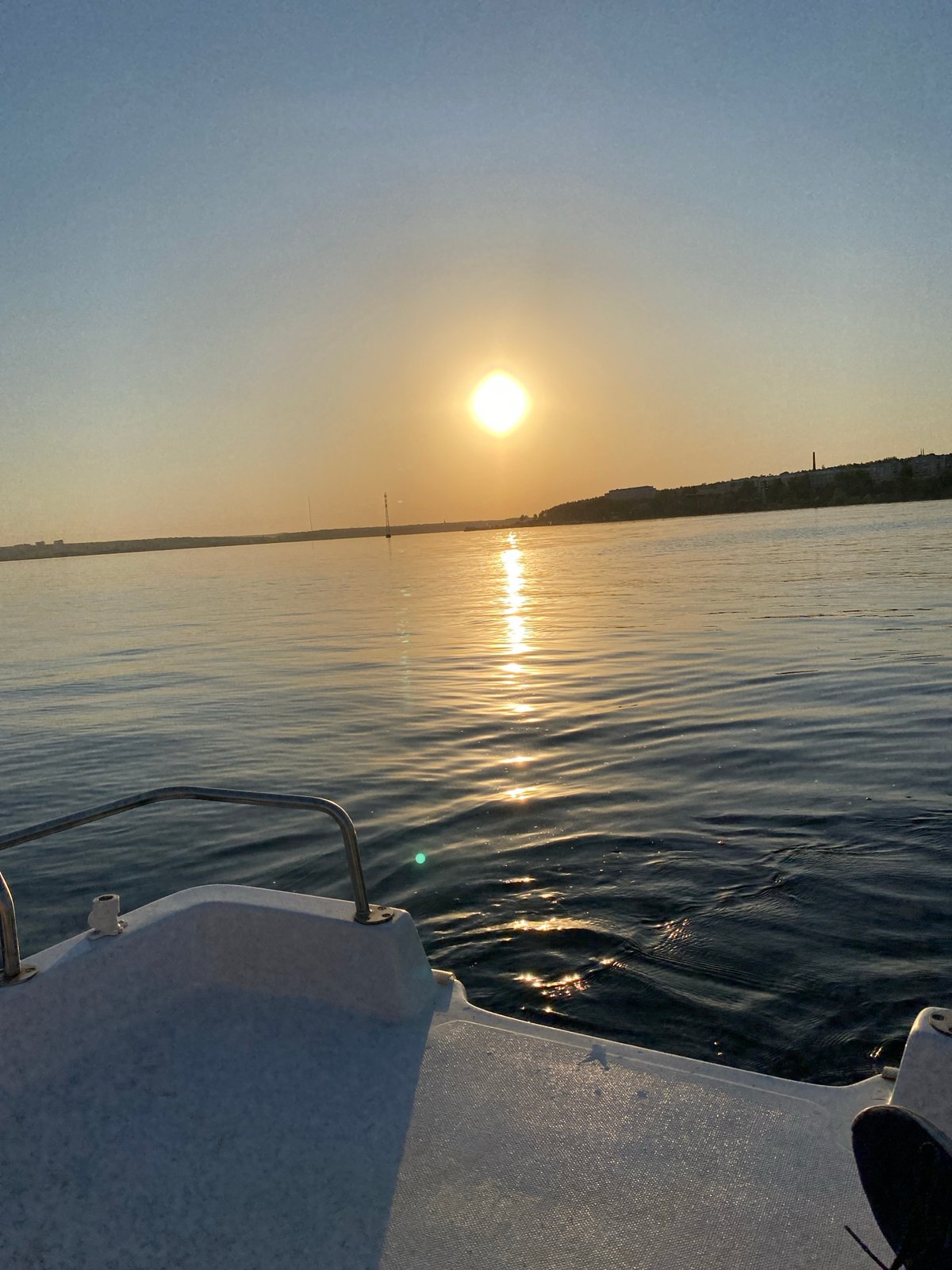 Boat excursion documented on Izhevsk waterway during golden hour