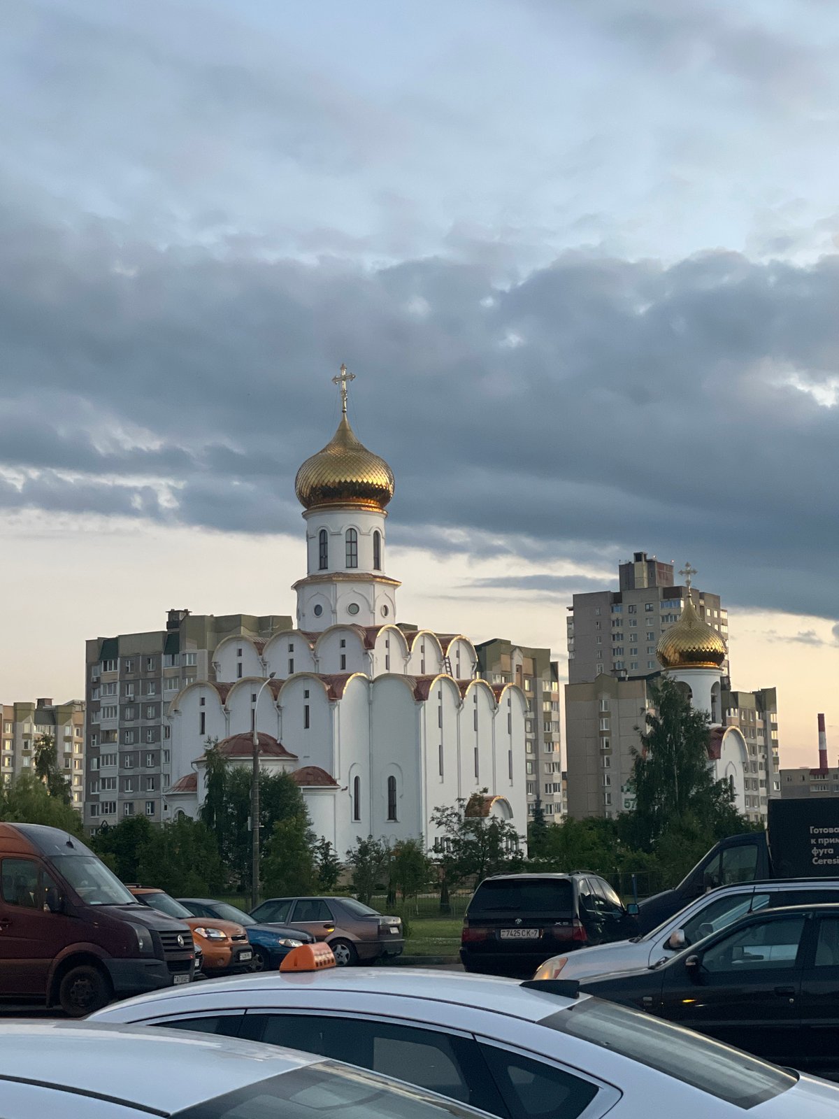 Orthodox church and Brutalist apartments share a Minsk street corner