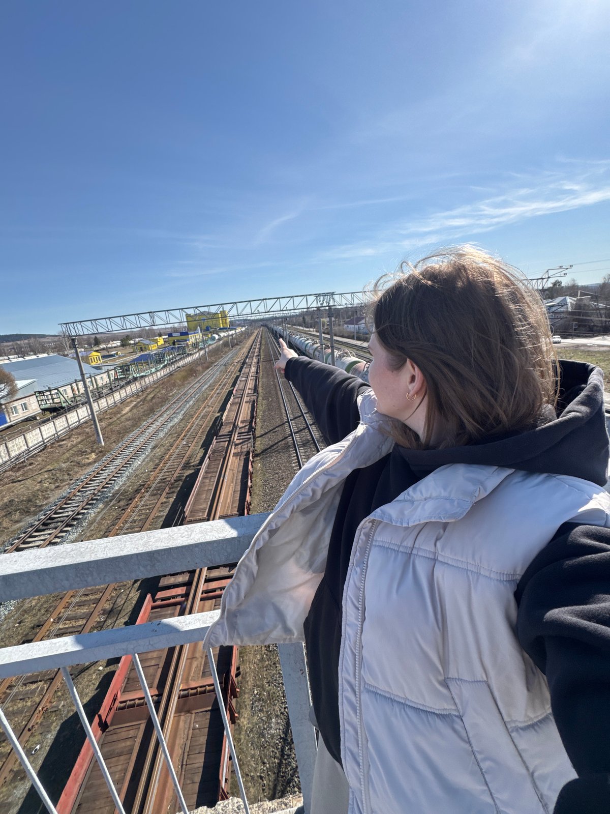Mother, child enjoy train-watching and playground visit in rural Russia
