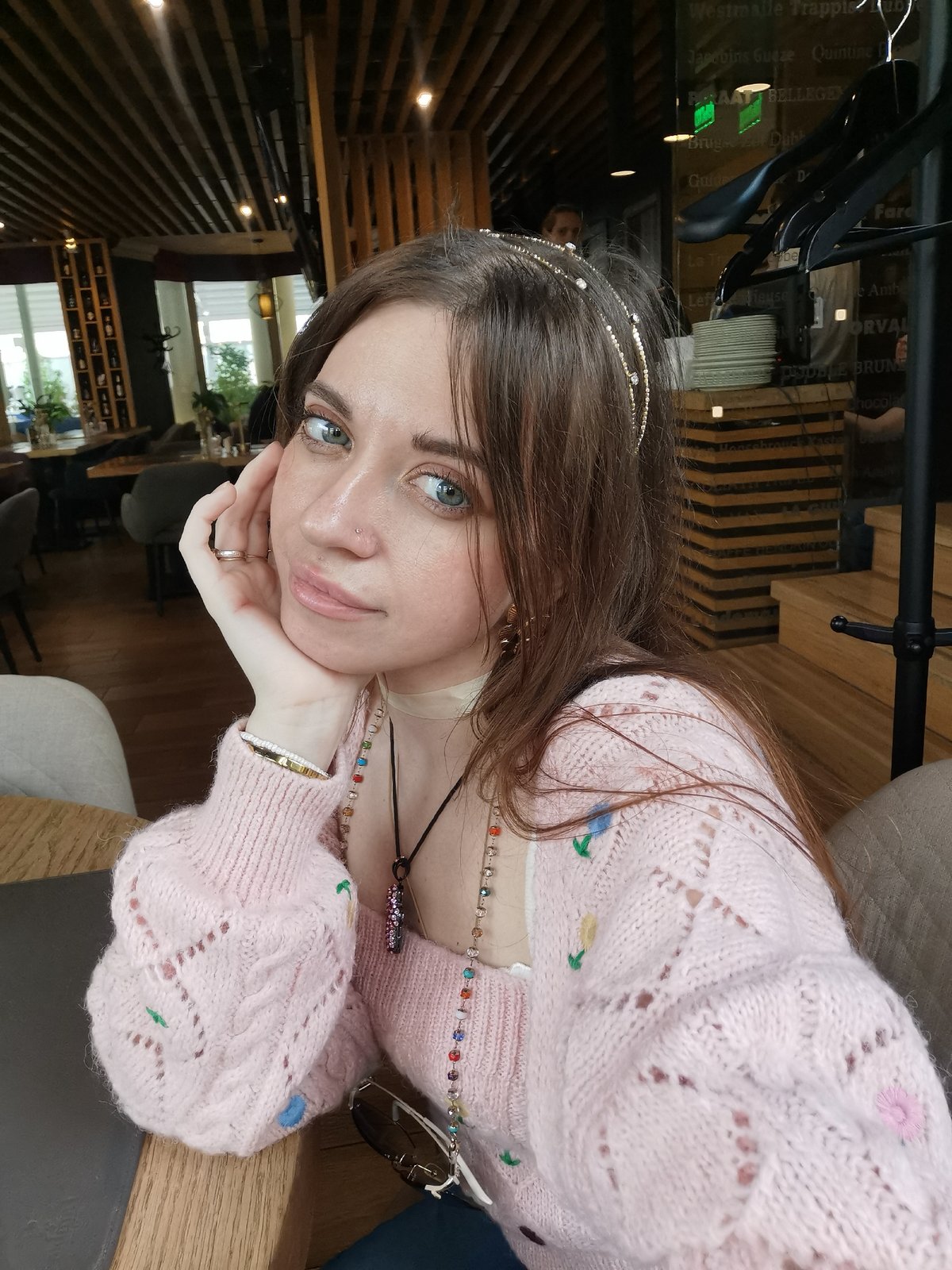 Woman photographs herself at Moscow cafe during afternoon visit