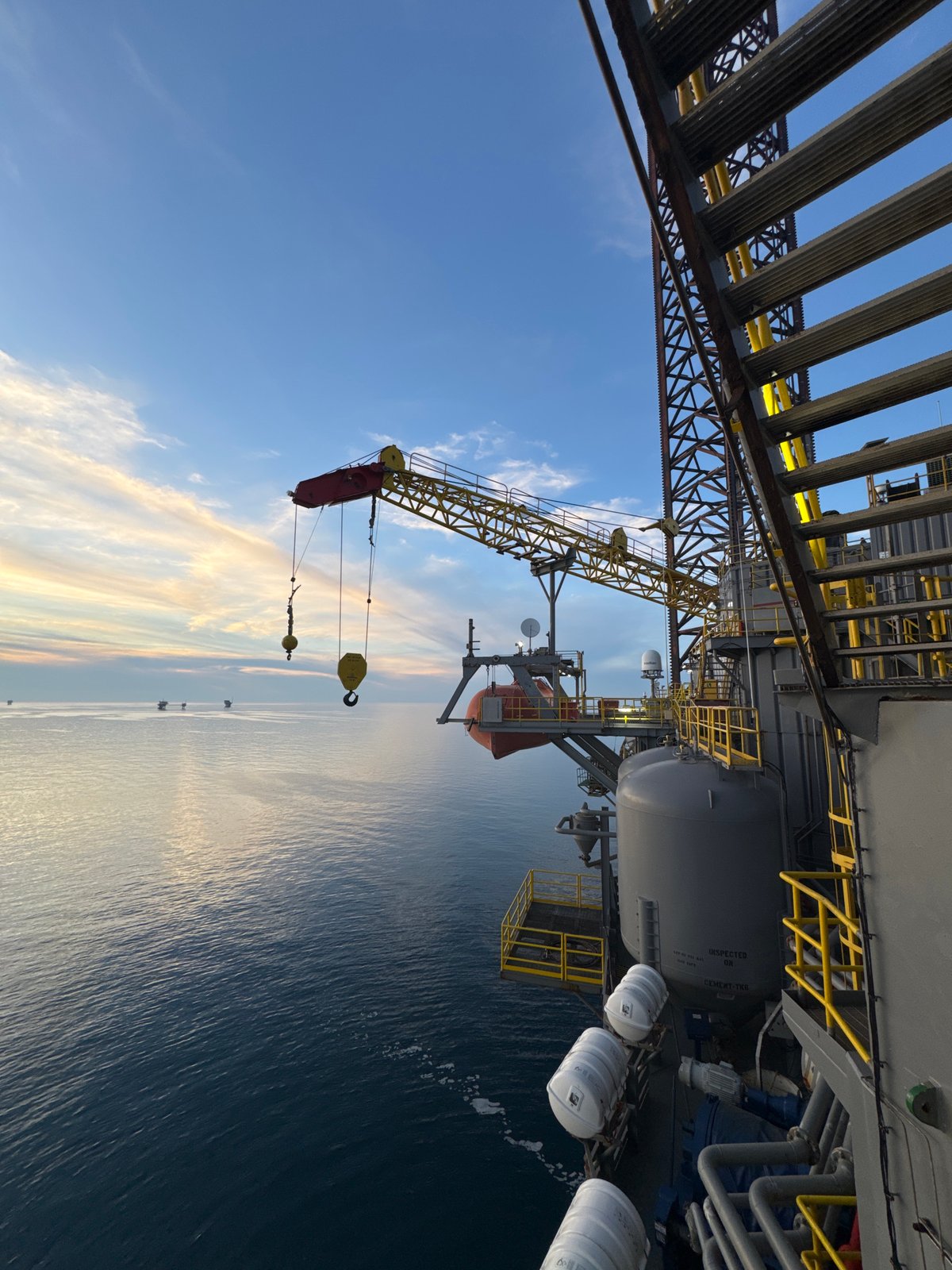 Offshore oil platform and support vessels at dusk, Adriatic Sea