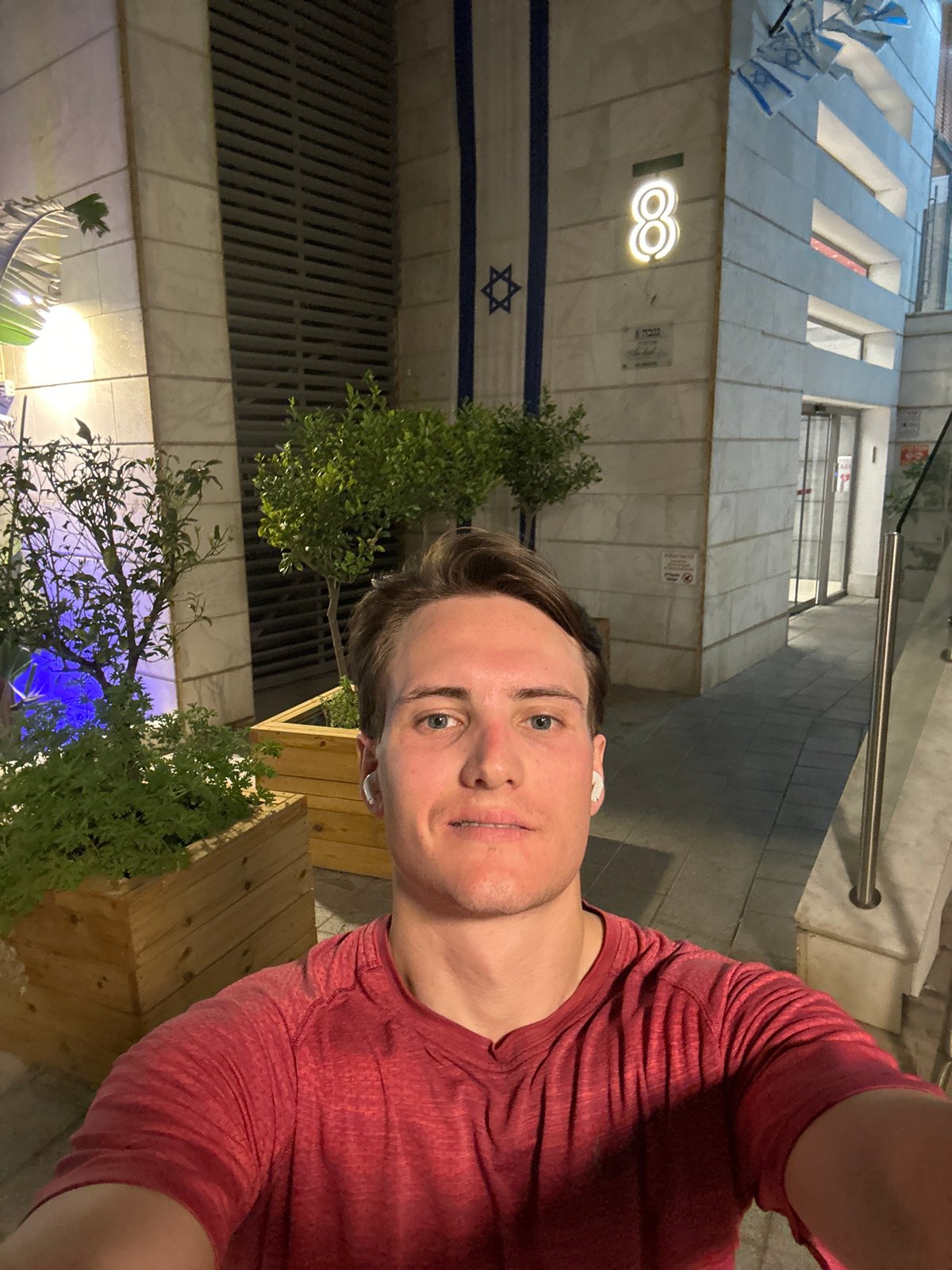 Man takes selfie near Israeli flag in Ramat Gan