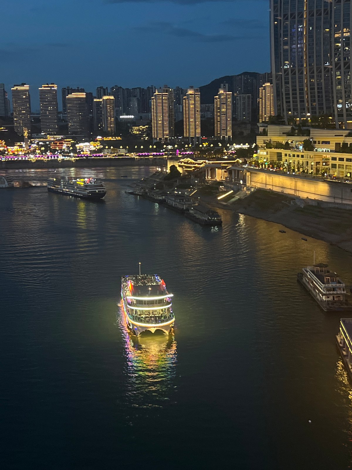 Chongqing's Yuzhong riverfront lights up at dusk