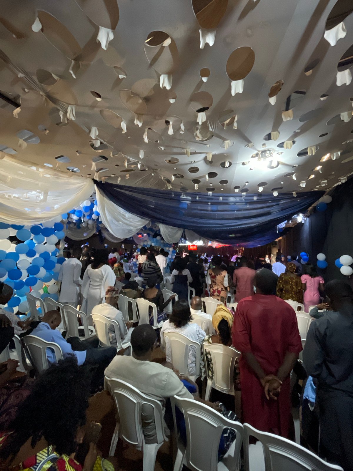 Indoor celebration with blue-white decorations across Nigerian venues
