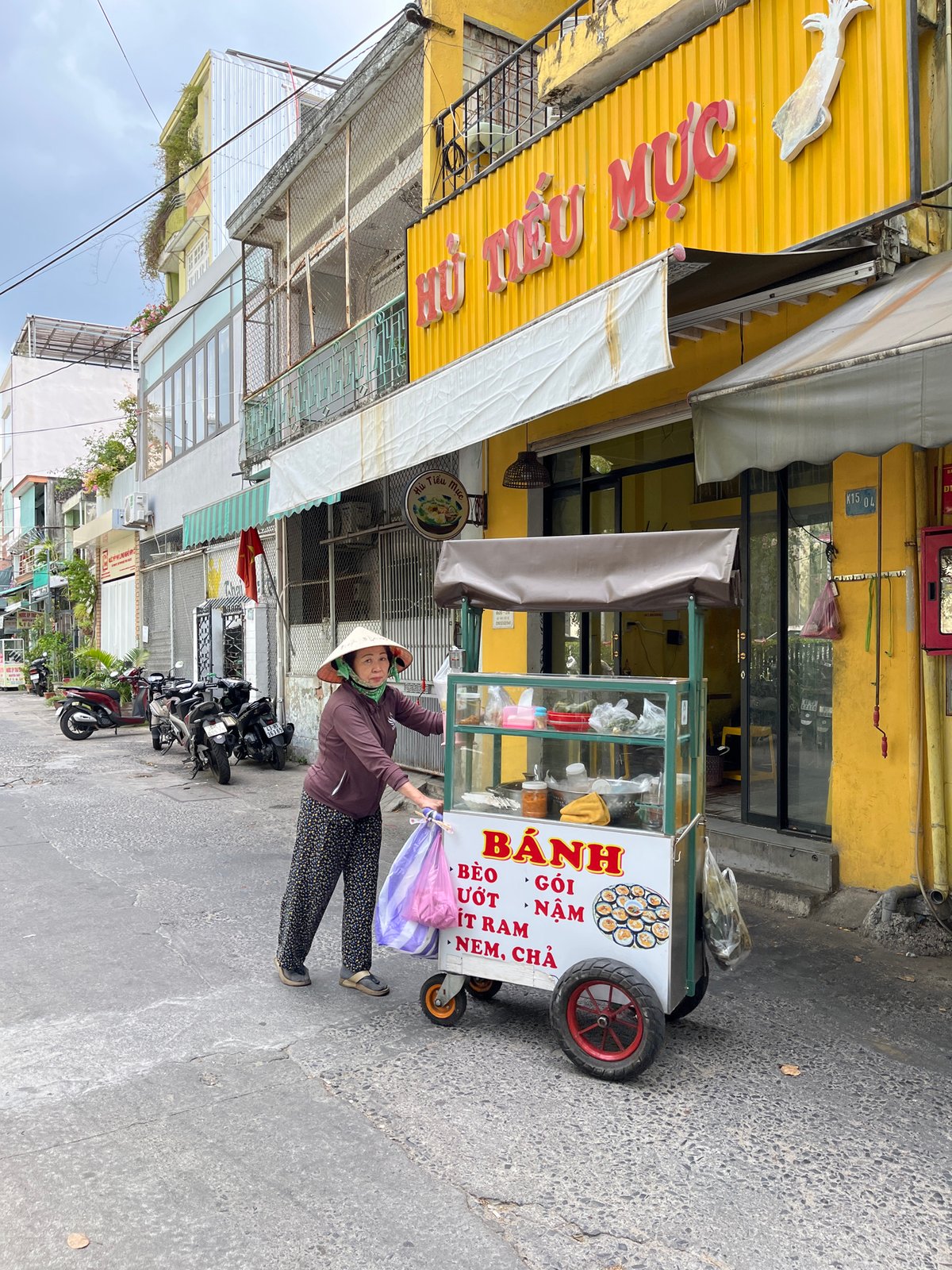 Morning street photography documents Da Nang cafes and storefronts