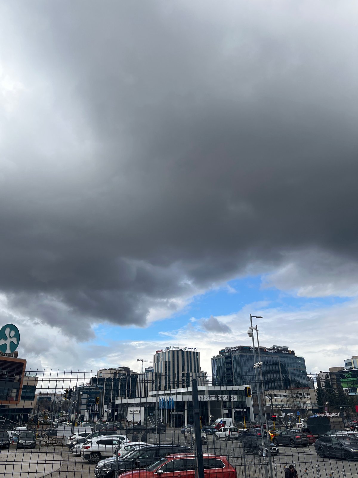 Dramatic storm clouds create split sky over Sofia office district