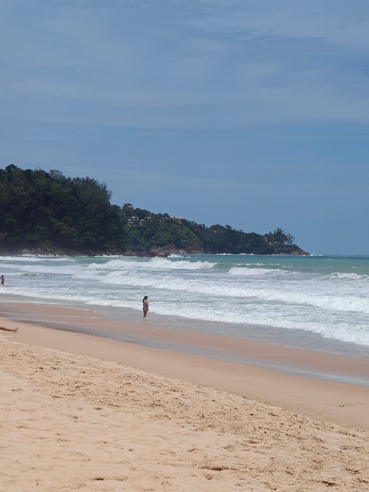 Red flag on a quiet Sakhu beach, calm morning waves