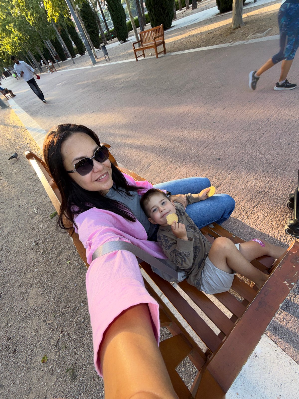Mother and child enjoy afternoon playground visit with selfies