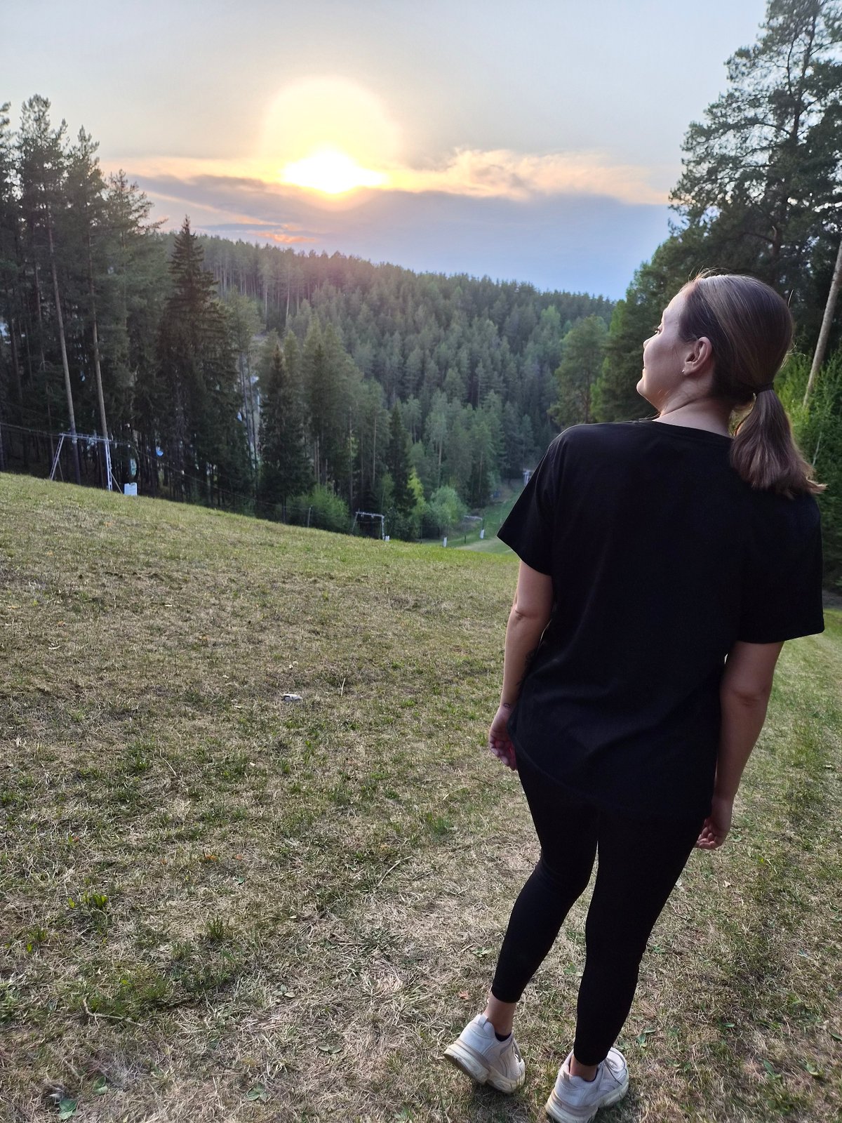 Woman exercises outdoors during sunset in Прикамский, Russia