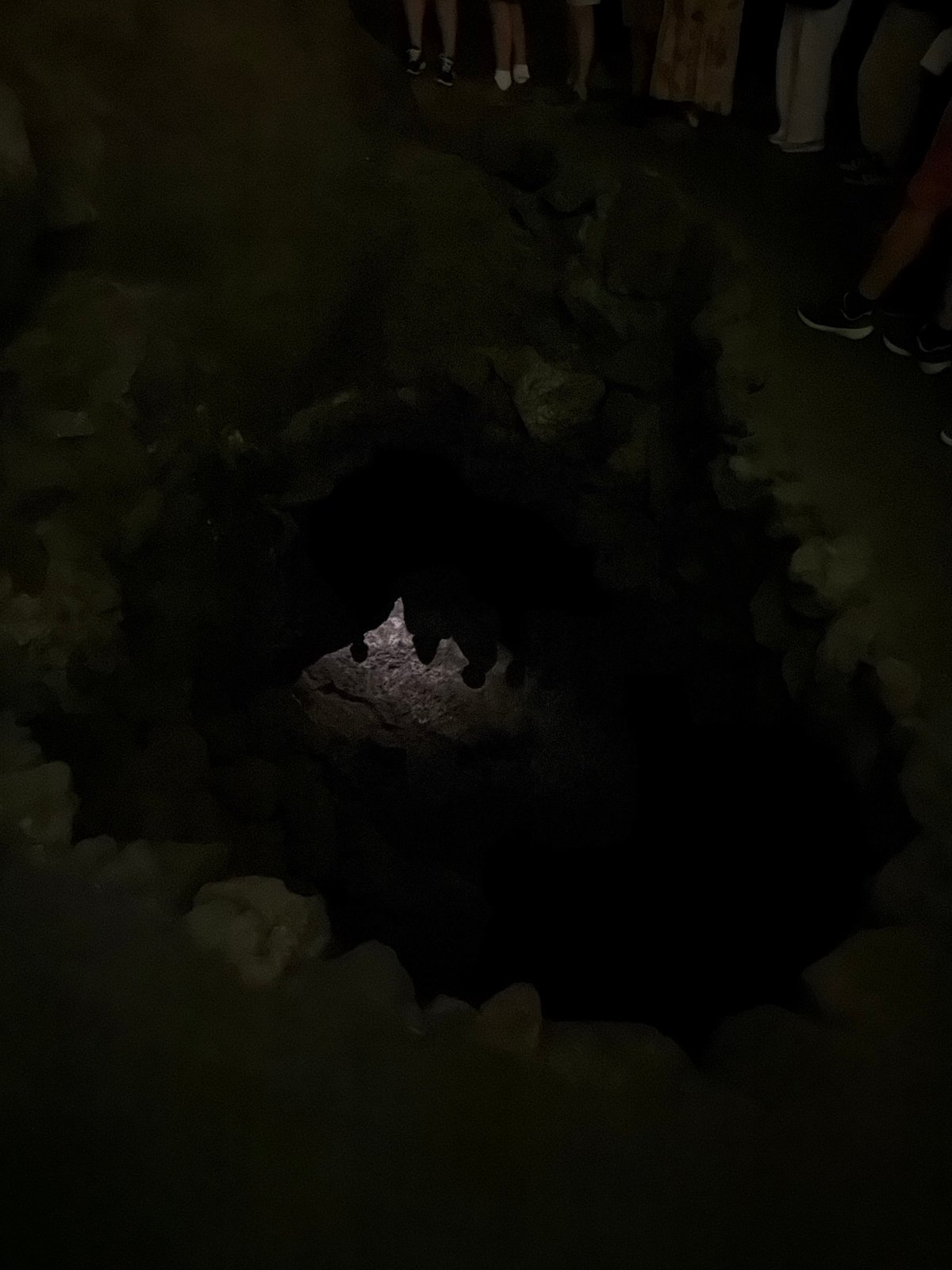 Tourist explores Cueva de los Verdes lava tube cave