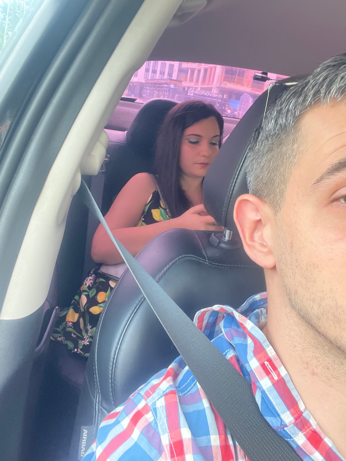 Passenger seat selfie in Sofia, colorful shirt in frame