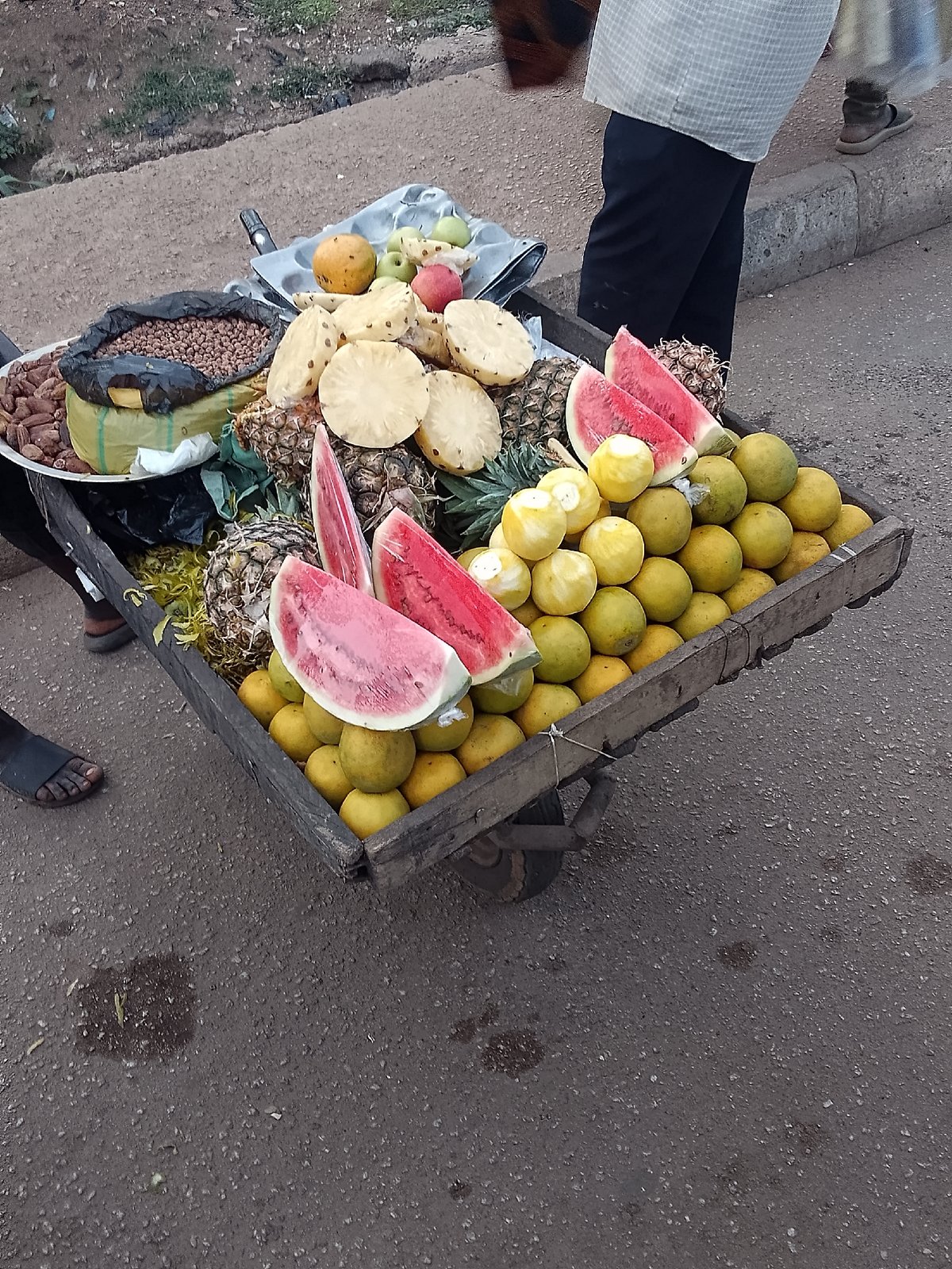 Street vendors sell fruits and nuts in Bukuru, Nigeria