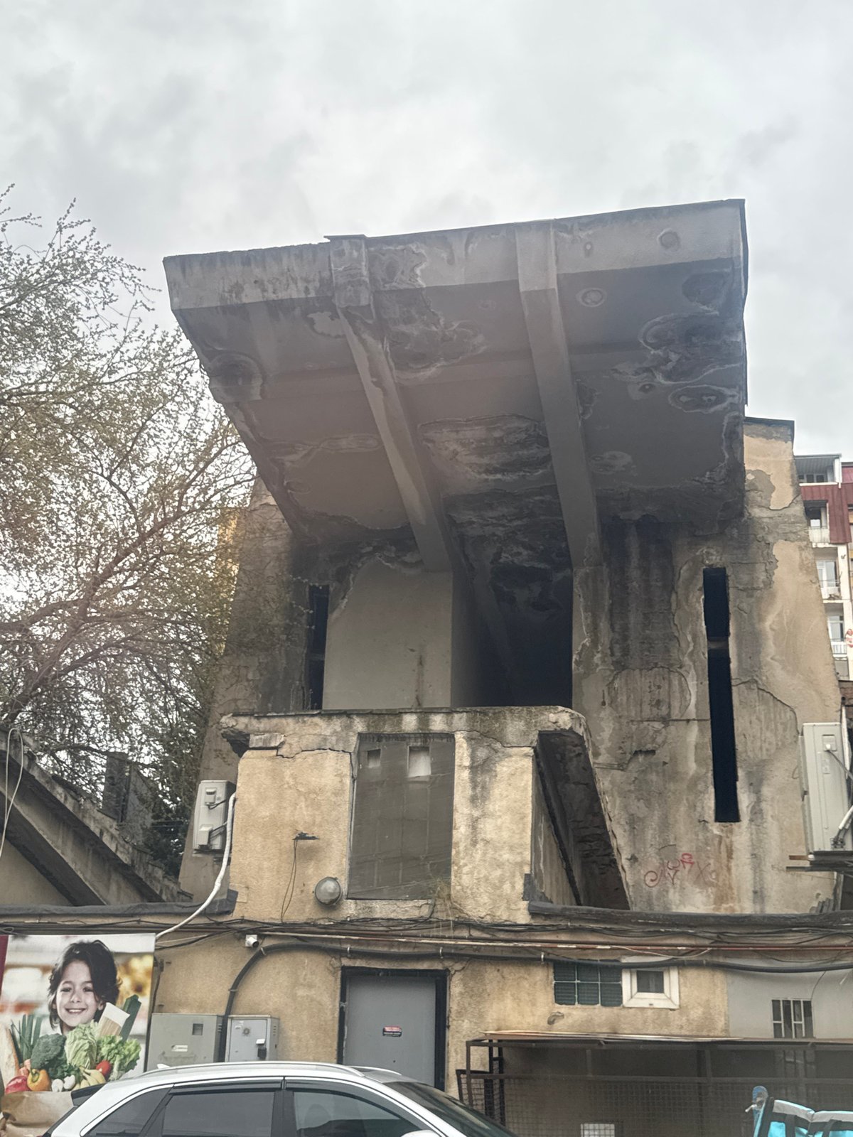 Observer documents weathered Tbilisi streetscapes and street art under overcast skies