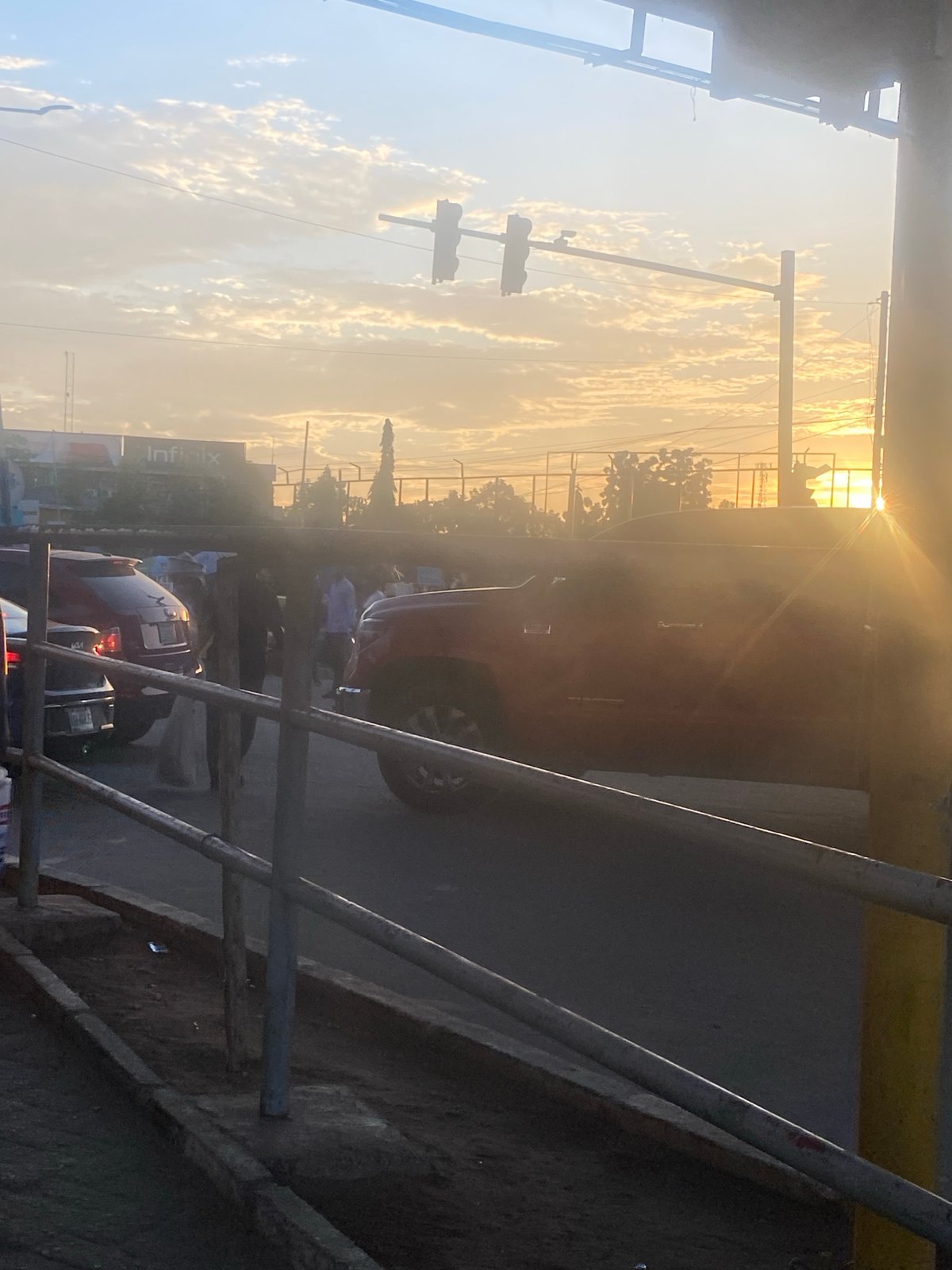 Sunset street life documented in Ikeja, Nigeria intersection