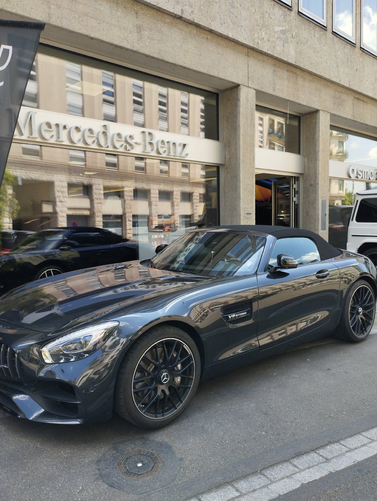 Scooters and Mercedes convertibles outside a Zurich dealership