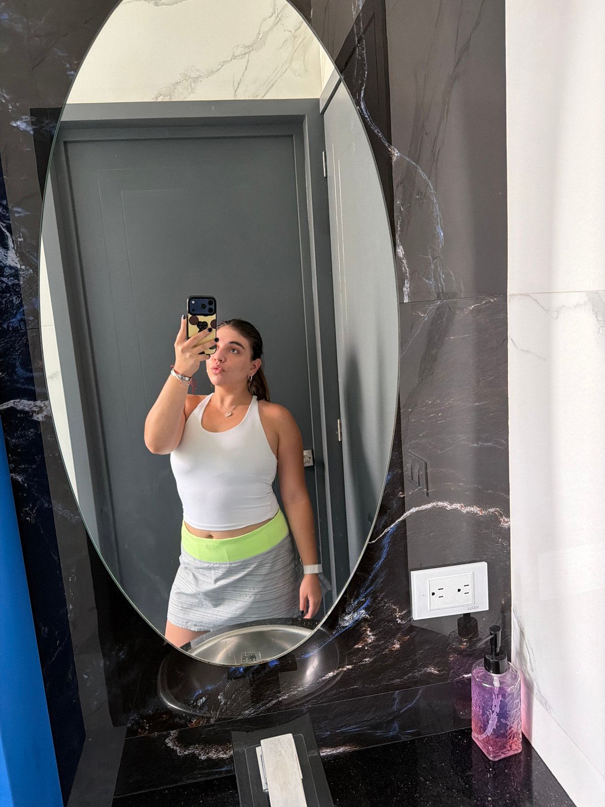 Woman takes bathroom mirror selfies in Puebla, Mexico