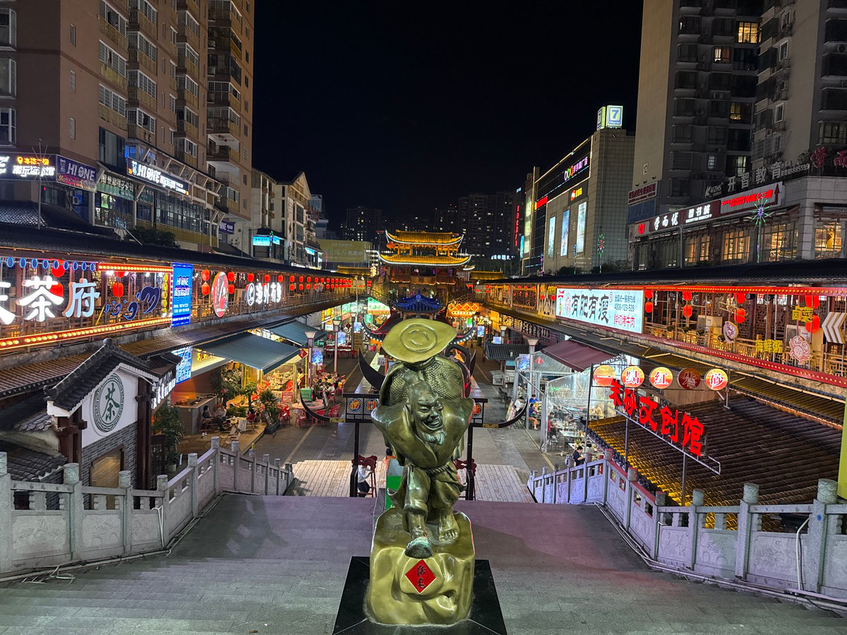 Night market bustles under neon lights in Zhangjiajie