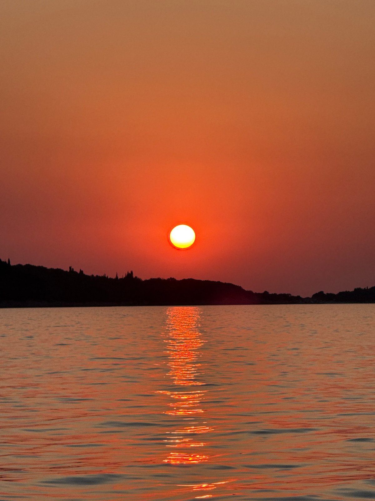 Dusk on the Adriatic: yacht, fortress, and sunset near Vitaljina